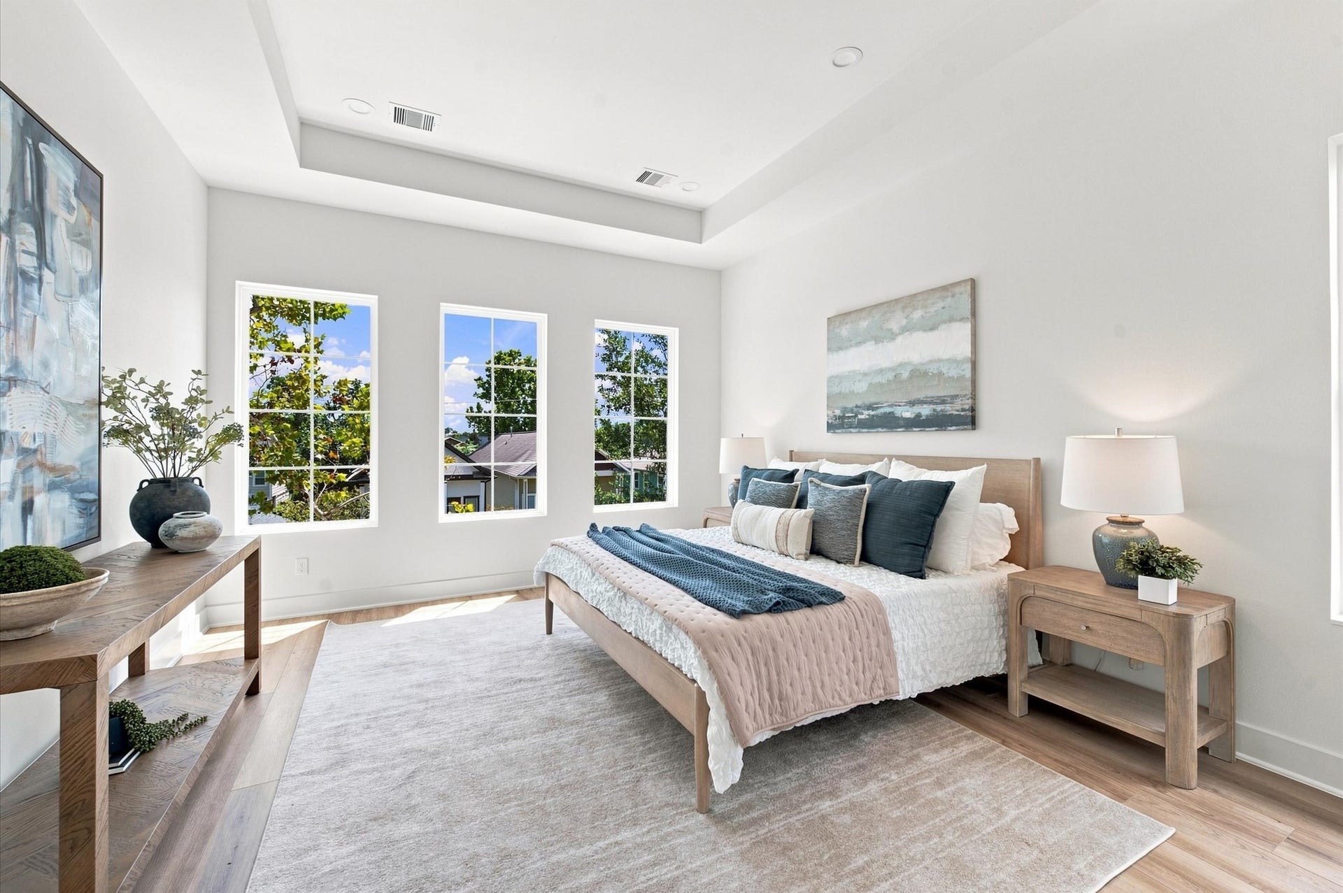 Primary bedroom has 11-ft high tray ceilings and an abundance of natural light.