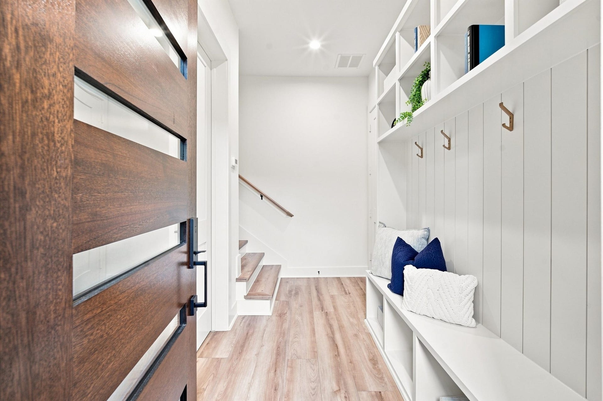 Mudroom with coat hangers upon entry
