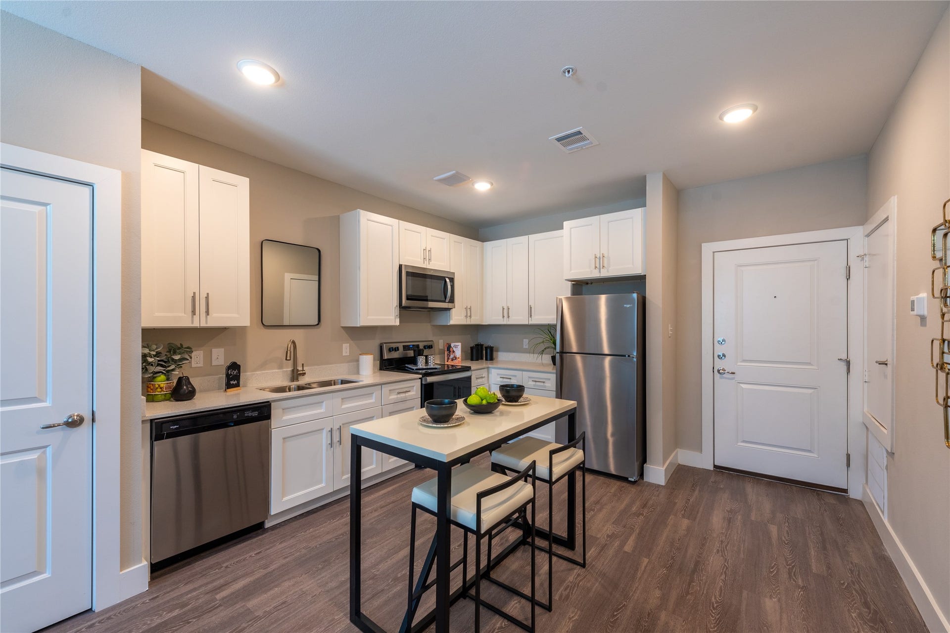 Modern kitchen featuring white cabinetry, and stainless steel appliances