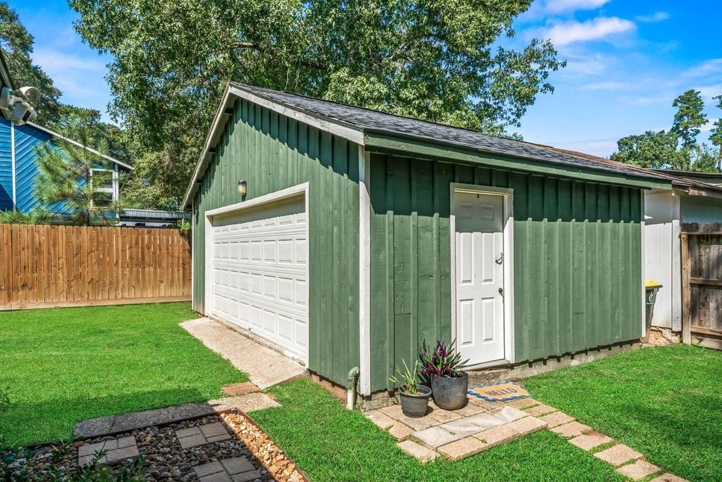 Garage with opener, newer door, exterior and roof