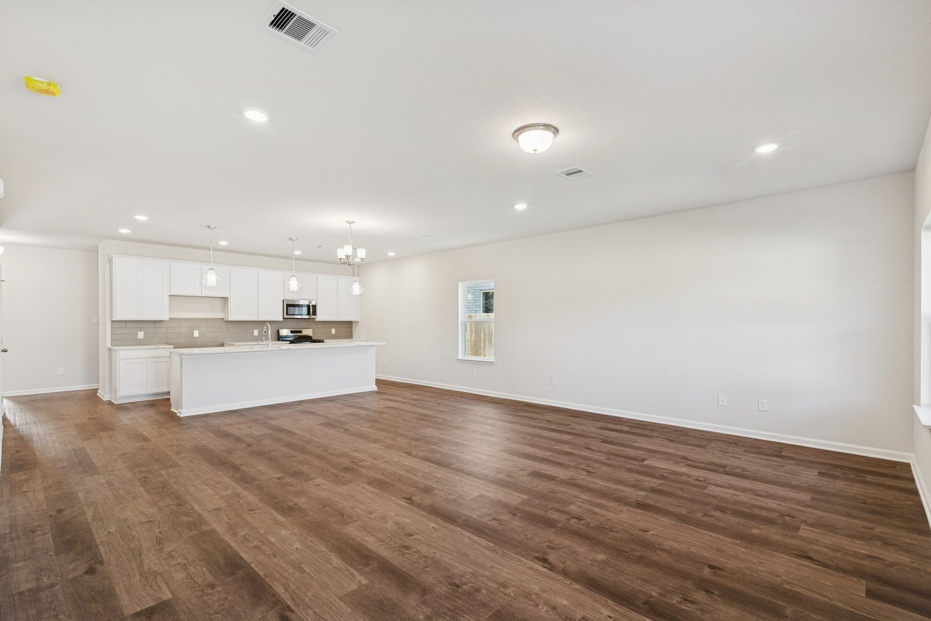 The Crawford- Family Room into Dining and Kitchen. Home under construction, sample photo used for illustrative purposes only, colors and options will vary.