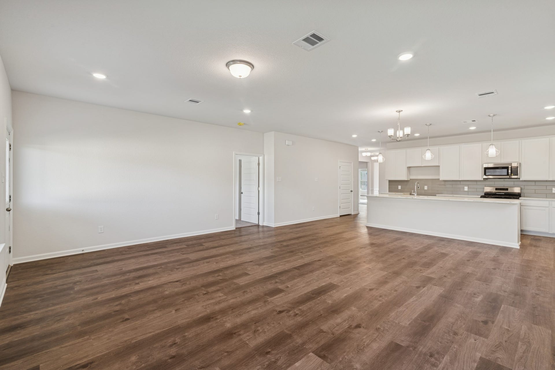 The Crawford- Family Room into Dining and Kitchen. Home under construction, sample photo used for illustrative purposes only, colors and options will vary.