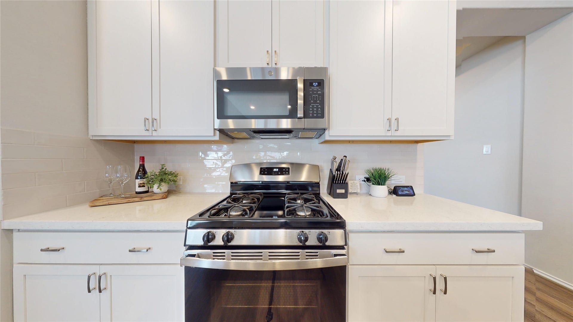 2926 Yaupon Grove Lane, Conroe, TX 77385 The kitchen features 42" cabinets, tiled backsplash, stainless steel appliances, and a walk-in pantry.