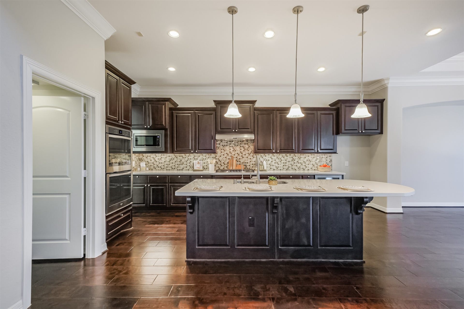 10 Silent Way Drive, Sugar Land, TX 77498 Chefs Dream! Expansive island kitchen featuring breakfast bar and pendant lamps.