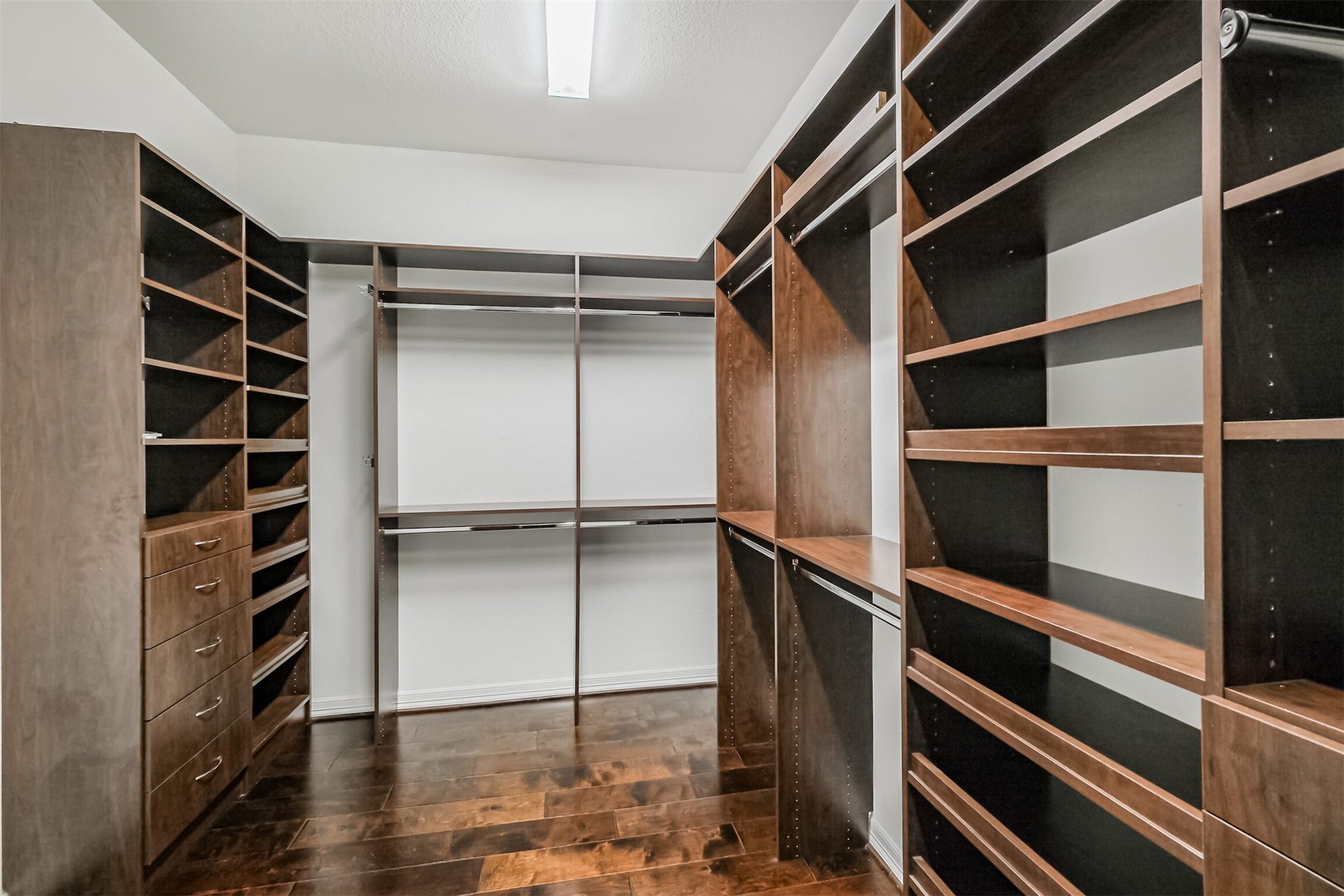 10 Silent Way Drive, Sugar Land, TX 77498 Well-designed built-in primary closet with shelving, drawers, and hanging racks.