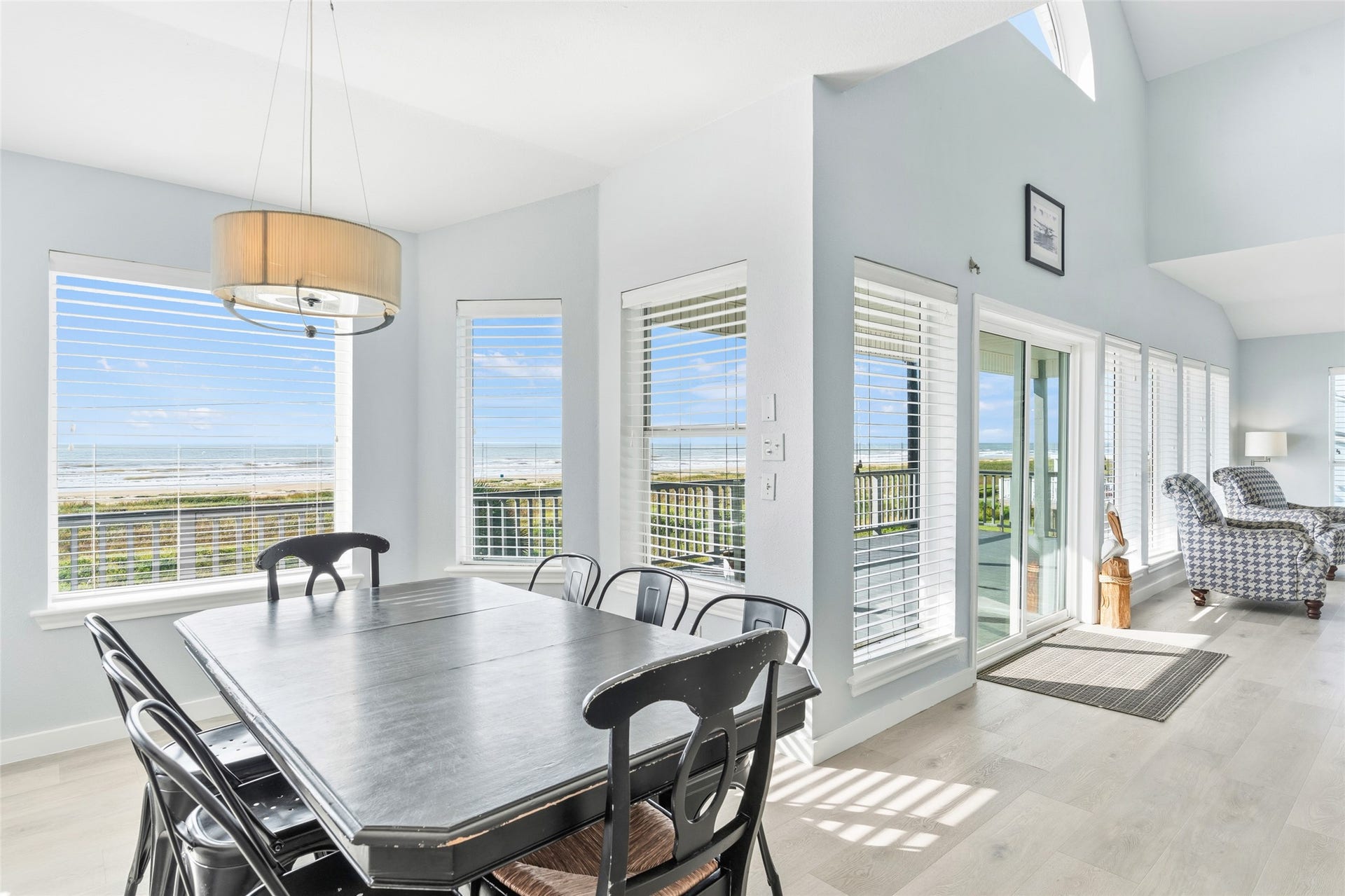21631 Termini San Luis Pass Road, Galveston, TX 77554 Enjoy the airy dining area with expansive views, featuring large windows and a seamless flow to the living space.