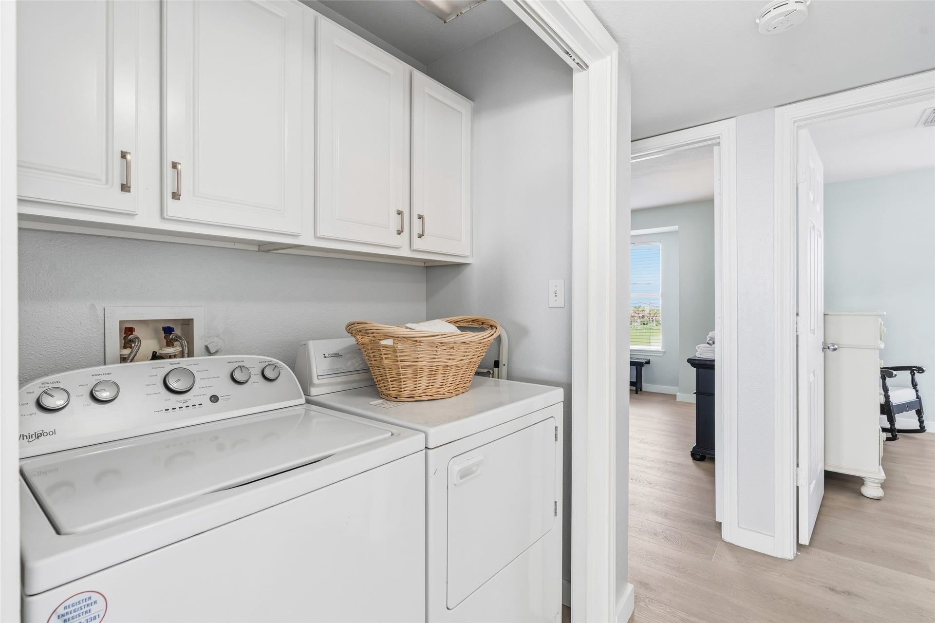 21631 Termini San Luis Pass Road, Galveston, TX 77554 Convenient laundry area with a washer and dryer, ample cabinets for storage, and easy access to adjacent rooms.