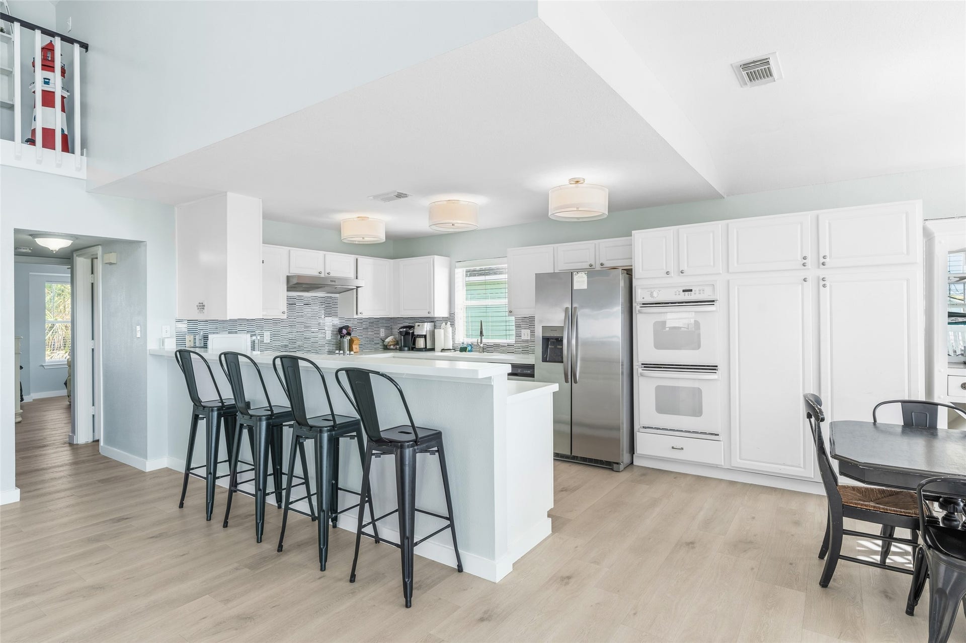 21631 Termini San Luis Pass Road, Galveston, TX 77554 Bright kitchen featuring ample cabinet space and a large breakfast bar with seating, perfect for casual meals and entertaining.