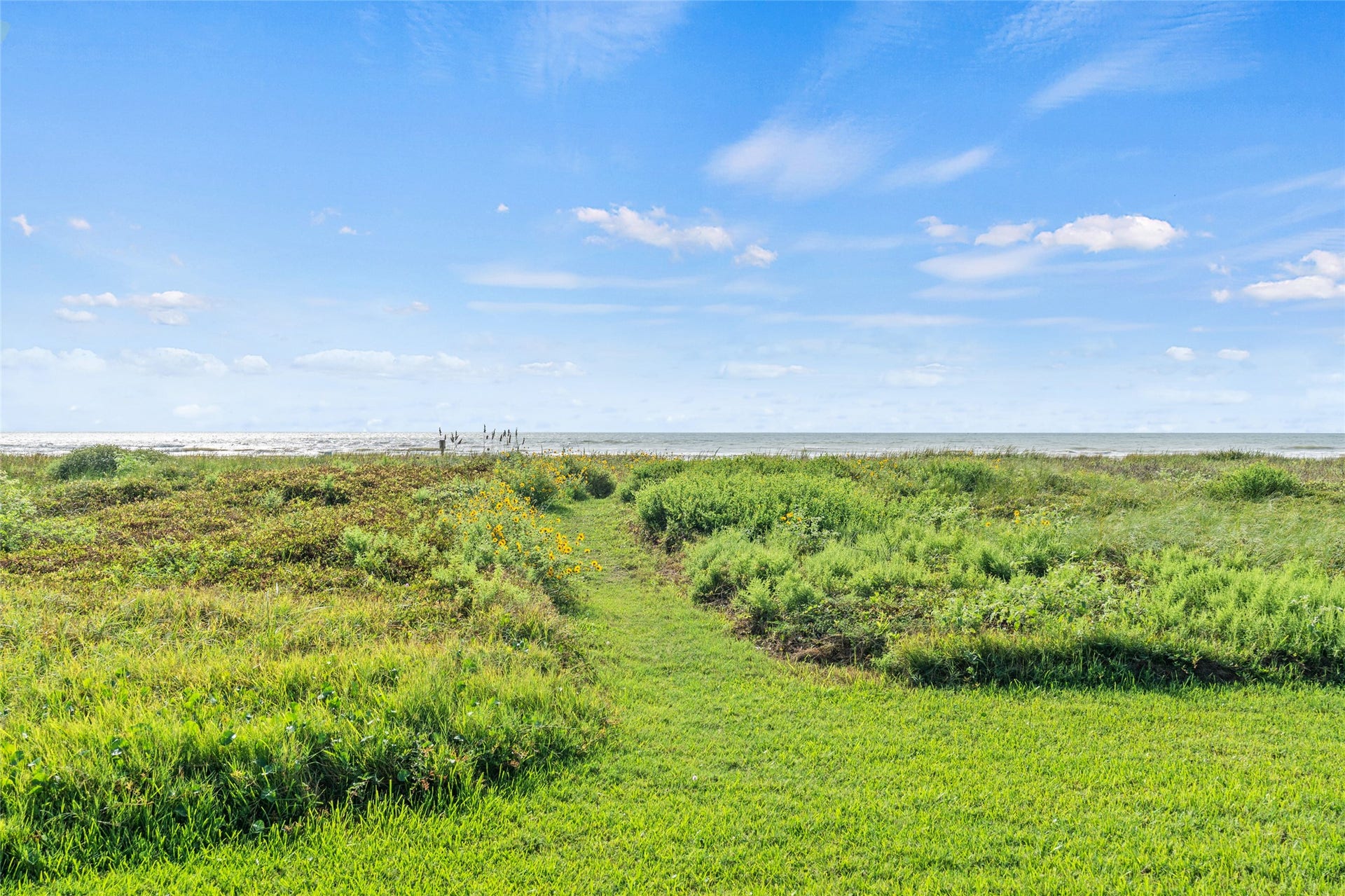 21631 Termini San Luis Pass Road, Galveston, TX 77554 Expansive coastal view with dunes leading to the ocean, perfect for enjoying nature and tranquility.