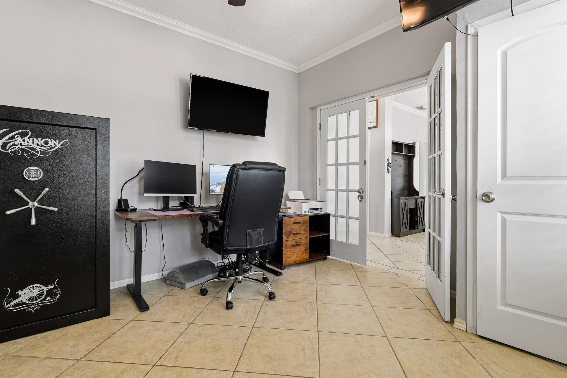 4811 Red Lantern Drive, Friendswood, TX 77546 Bright, functional home office with tiled floors and elegant French doors leading to the adjacent room.