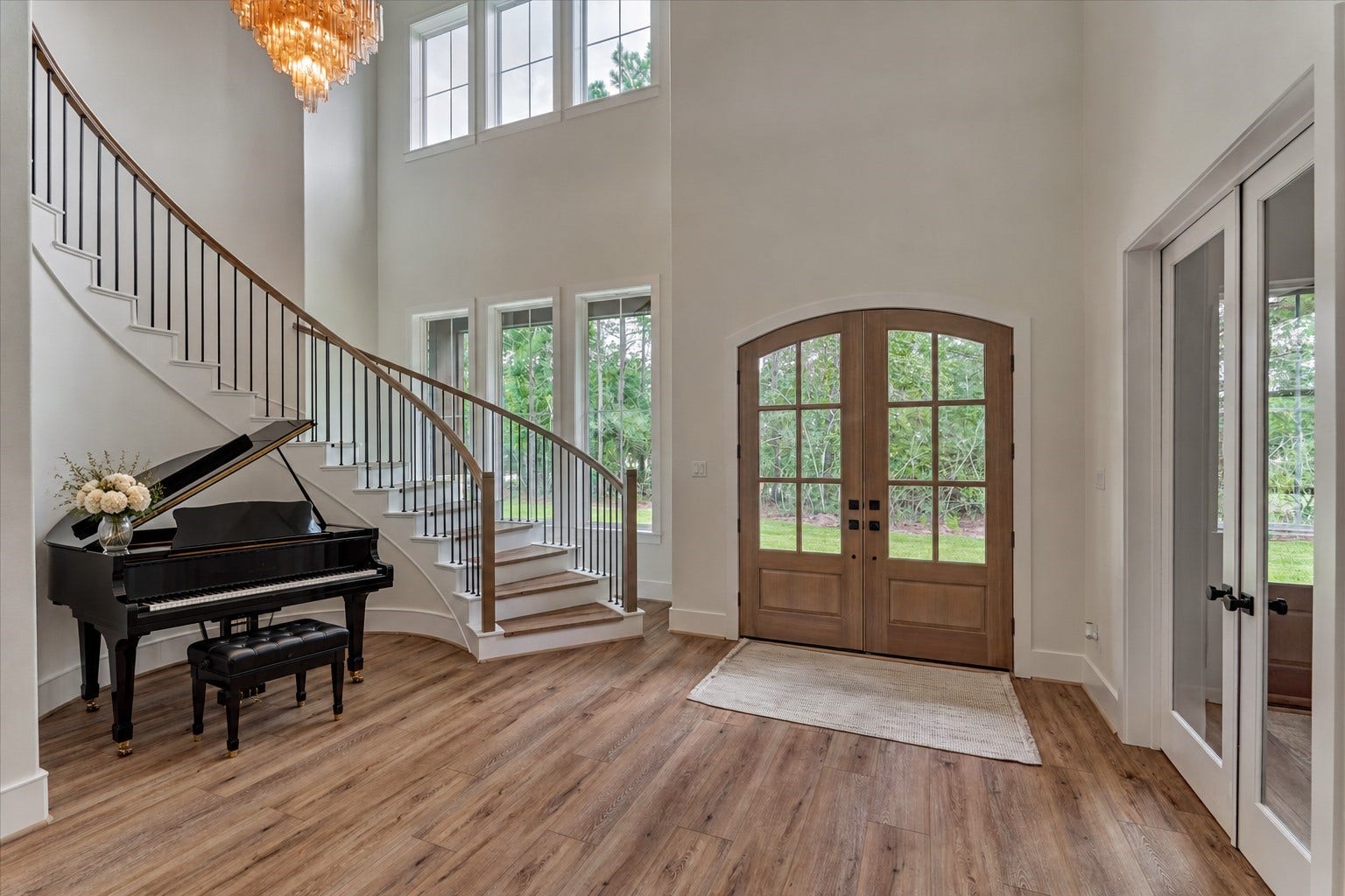 8616 Grand Lake Estates Drive, Montgomery, TX 77316 *This is a virtually staged photo* Take a moment to appreciate the grand foyer, highlighted by a sweeping staircase leading to the second floor and plenty of room for a statement piece, such as an entryway piano.