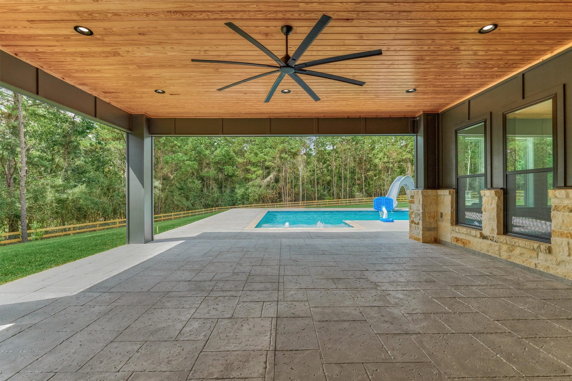 8616 Grand Lake Estates Drive, Montgomery, TX 77316 Endless possibilities await on this oversized covered patio, complete with a massive ceiling fan and plenty of room for outdoor lounge and dining furniture, grills, and more!
