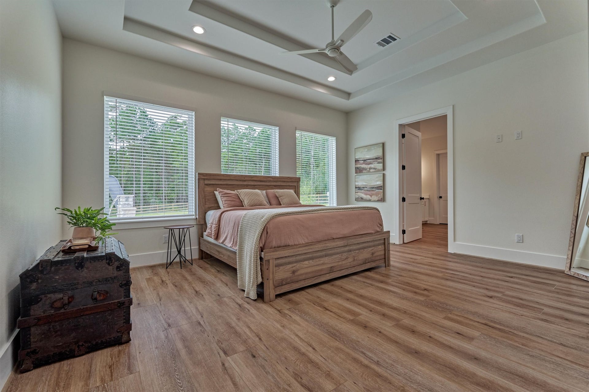 8616 Grand Lake Estates Drive, Montgomery, TX 77316 The owners retreat is truly an at-home sanctuary, showcasing impeccable design and generous space, with abundant natural light and an elegant tray ceiling.
