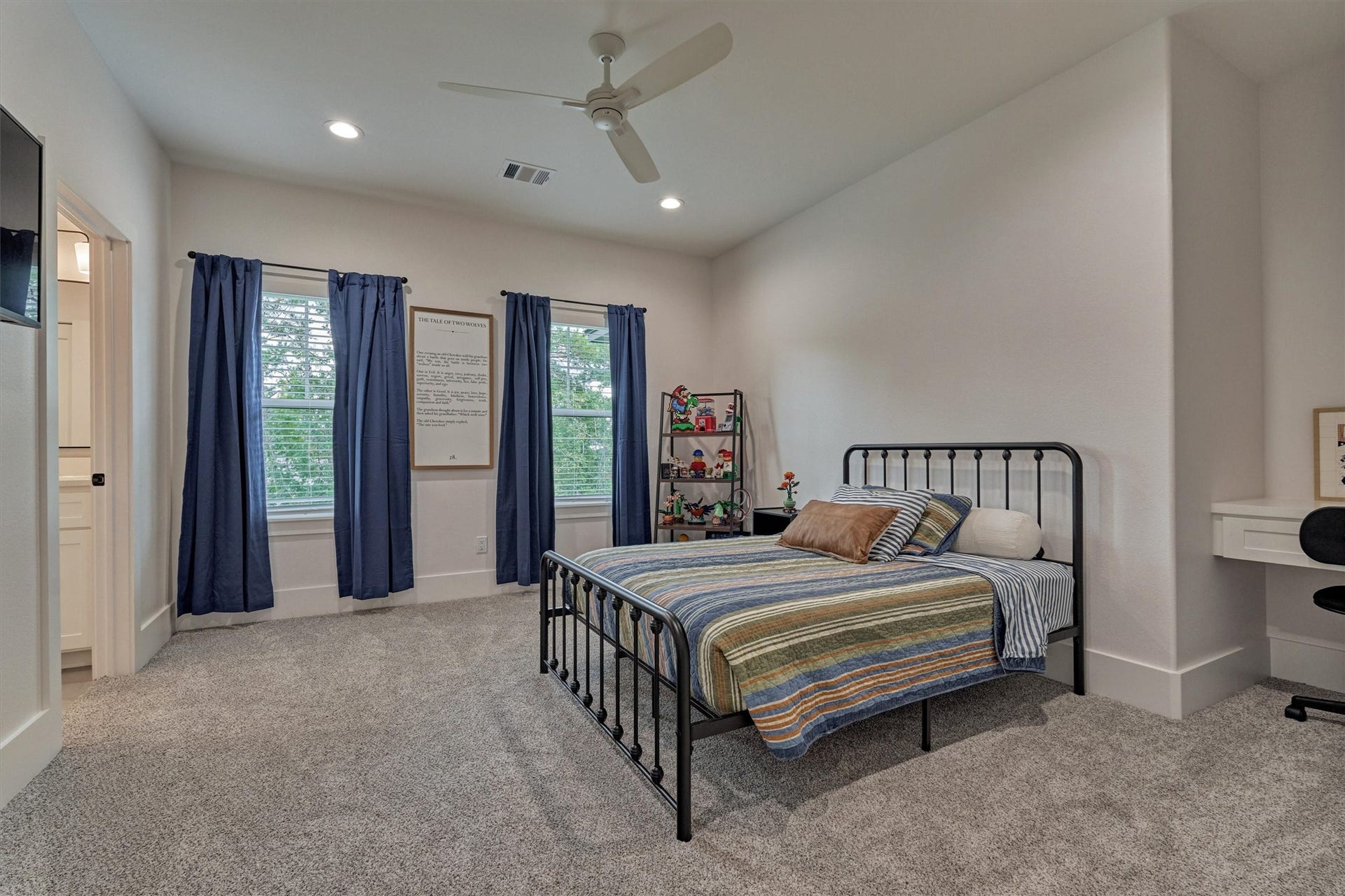 8616 Grand Lake Estates Drive, Montgomery, TX 77316 Secondary Bedroom #3 offers generous space, a built-in desk, a walk-in closet, and access to the Jack-and-Jill bathroom shared with Secondary Bedroom #2.