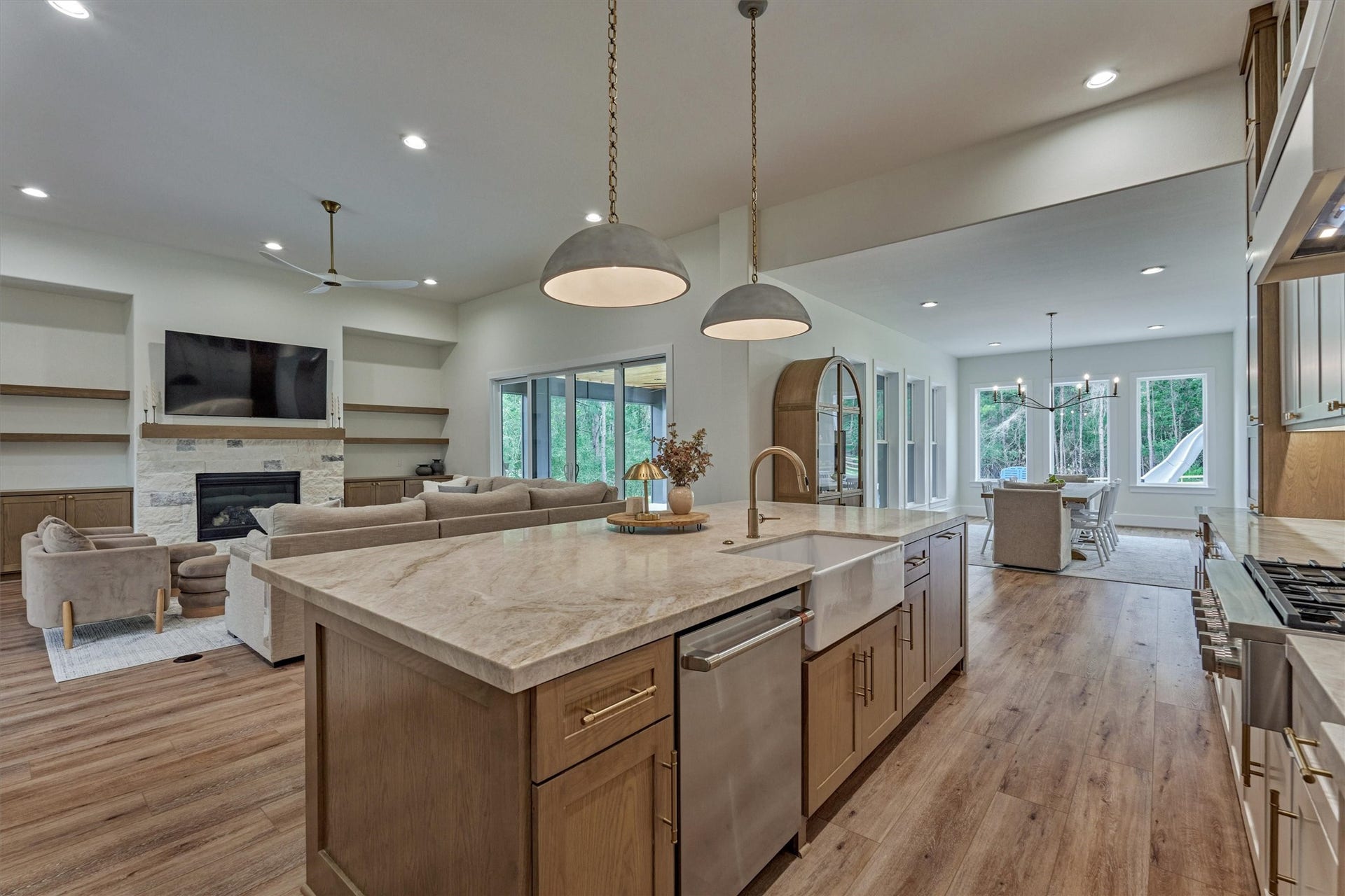8616 Grand Lake Estates Drive, Montgomery, TX 77316 The grand kitchen opens seamlessly to the den and dining room, all drenched in superb natural light.