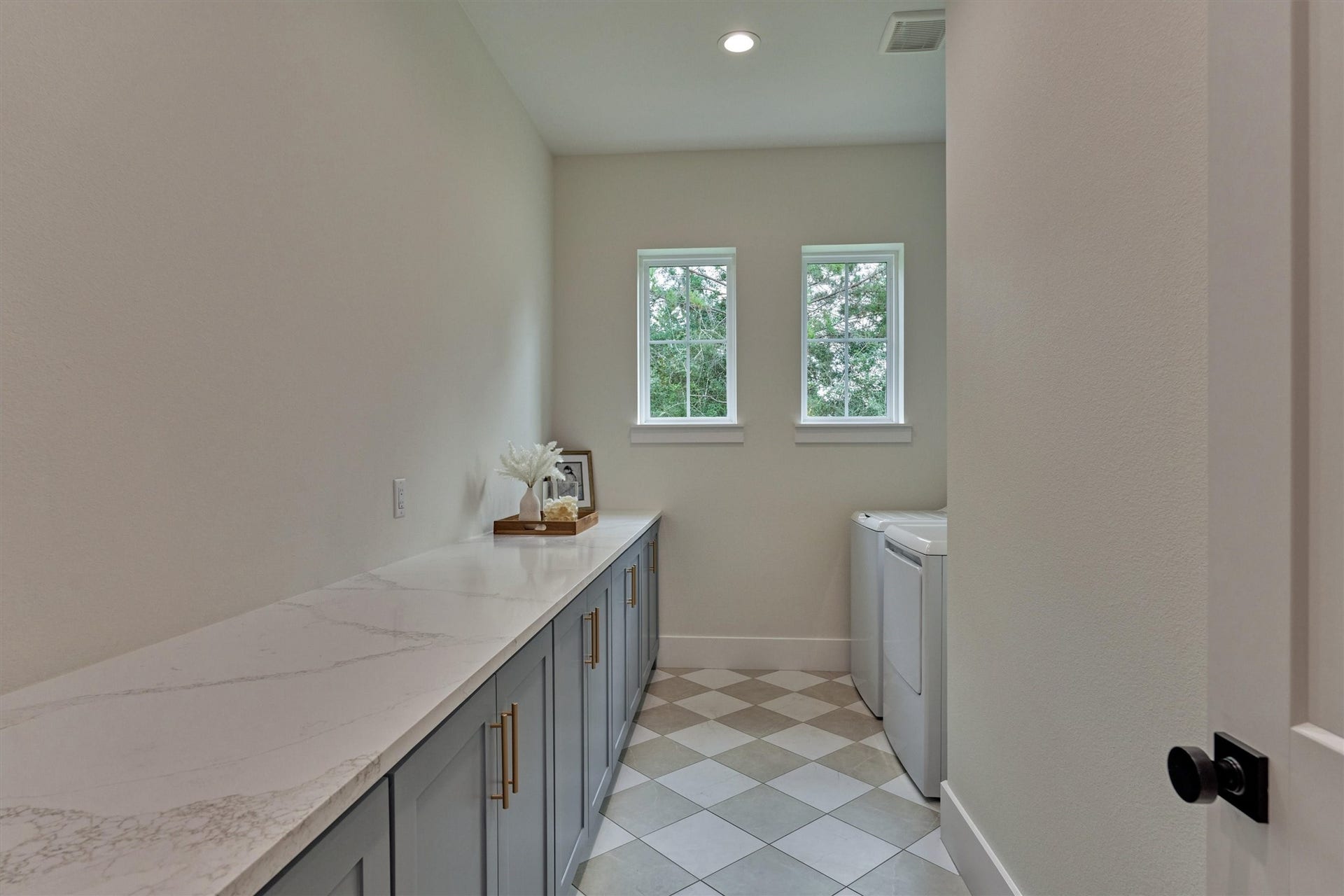 8616 Grand Lake Estates Drive, Montgomery, TX 77316 Dreamy utility room offers exceptional space, complete with an expansive countertop for folding, organizing, and more!