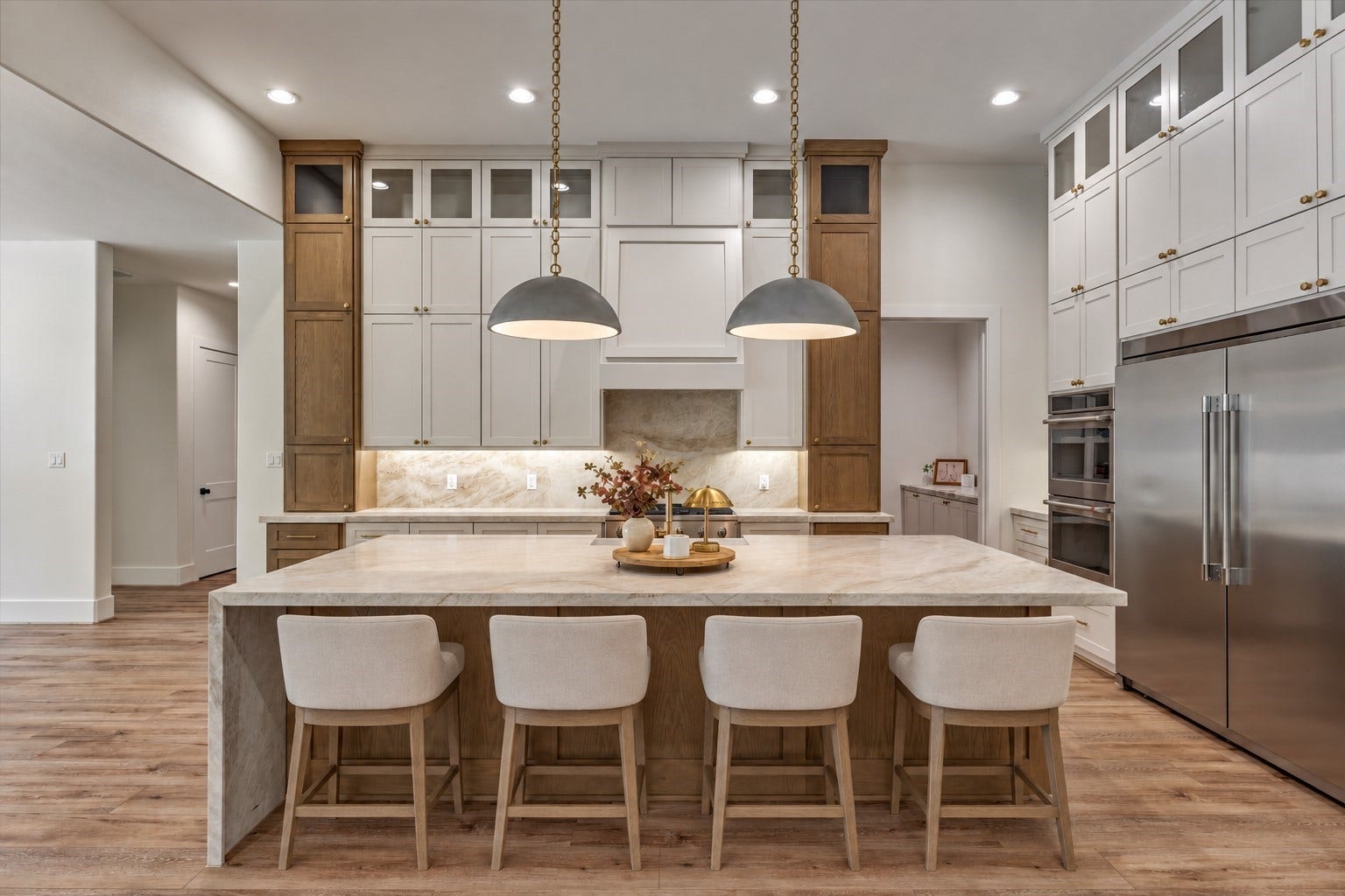 8616 Grand Lake Estates Drive, Montgomery, TX 77316 *This is a virtually staged photo* Appointed with all the amenities you could want and more, this kitchen stuns with double ovens, a grand B-I refrigerator, and custom cabinetry with glass-paneled display cabinets.