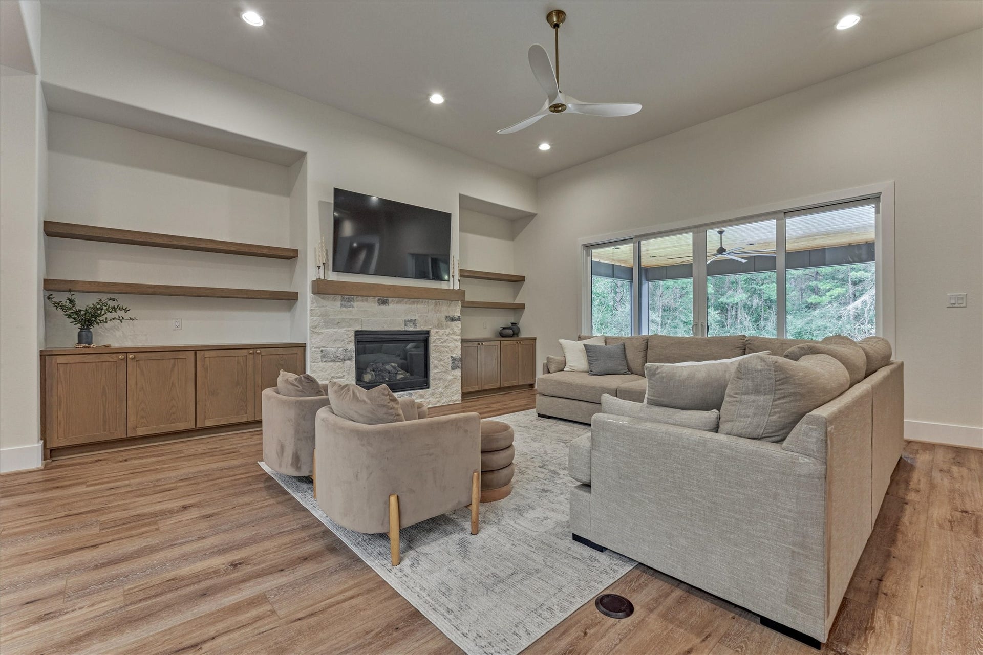 8616 Grand Lake Estates Drive, Montgomery, TX 77316 The den is drenched in natural light, with a wall of windows showcasing picturesque views of the backyard paradise.