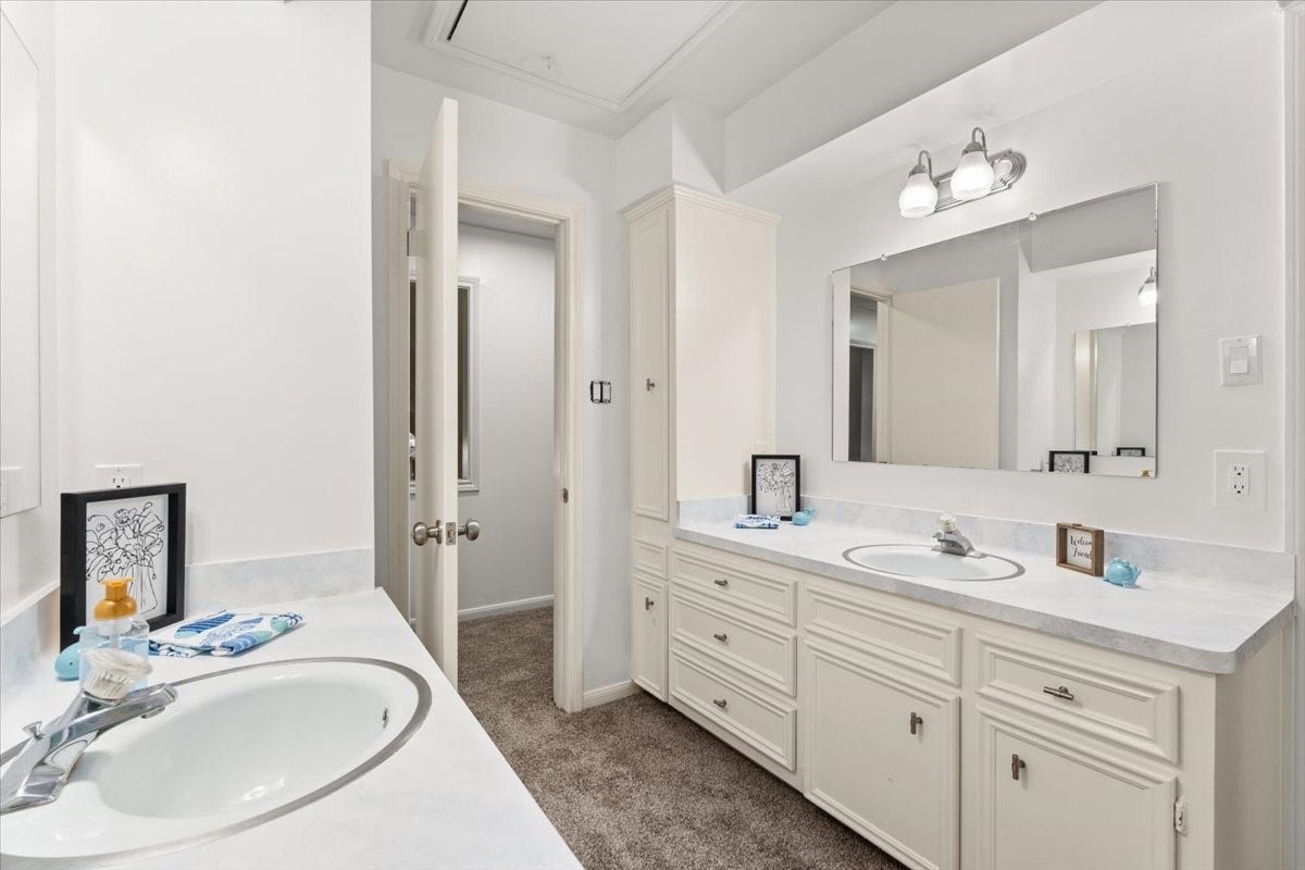 The upstairs bathroom has two separate vanities and is situated between two of the bedrooms.