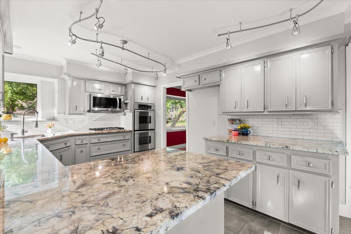 This lovely kitchen is located between the dining area and breakfast area with easy access to the living area.  Look at all of this storage space1