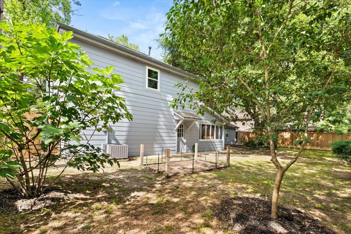 The side yard has fruit trees and plenty of room for a garden, jungle gym, or other fun & games