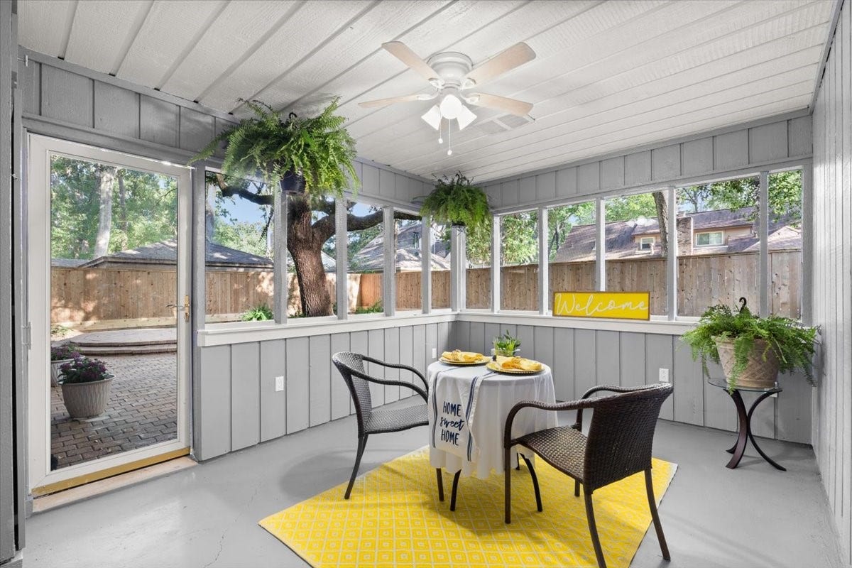 The sunroom has been completely updated with new plexiglass windows, paint, ceiling fan and more.