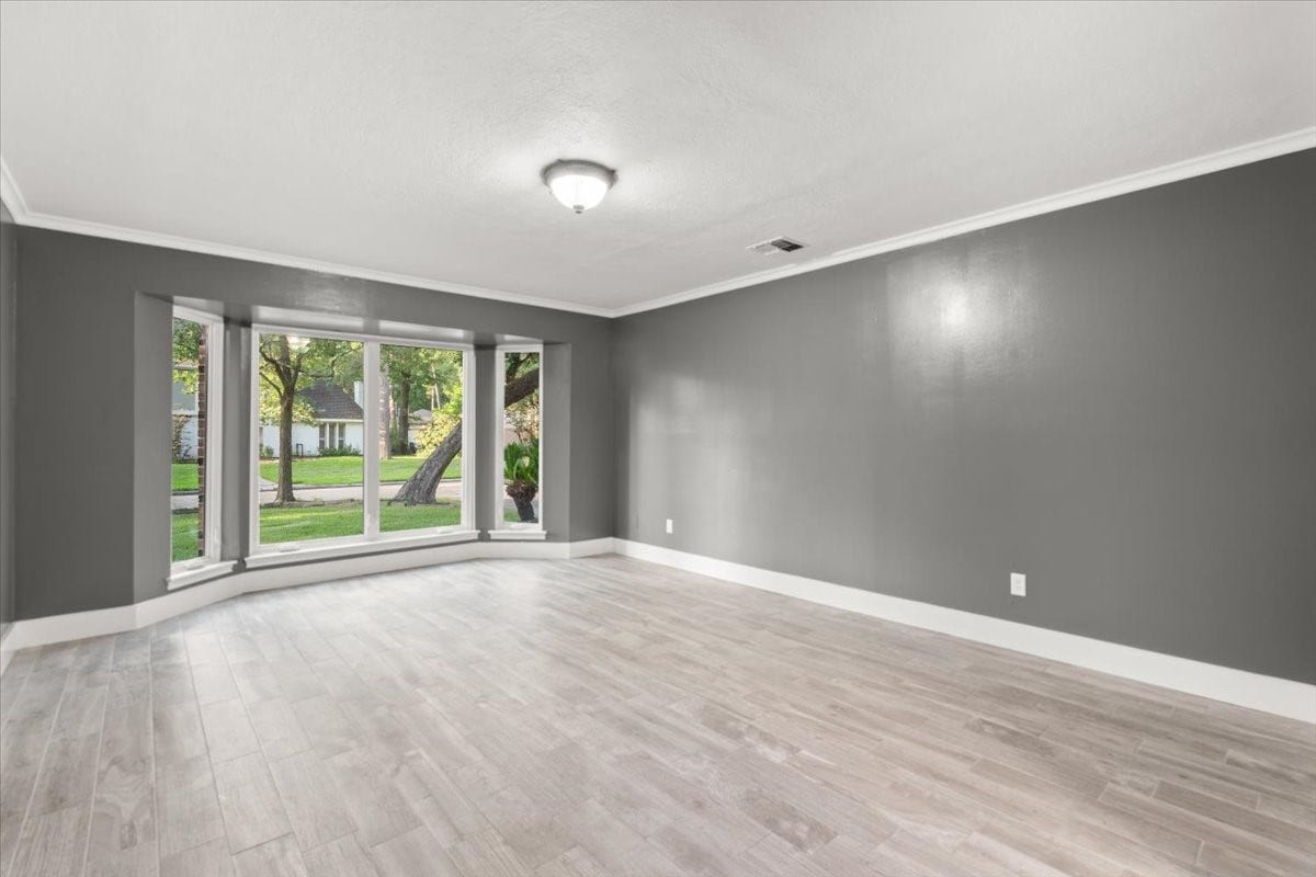 Spacious primary bedroom with ample room for
furniture and a cozy sitting area.