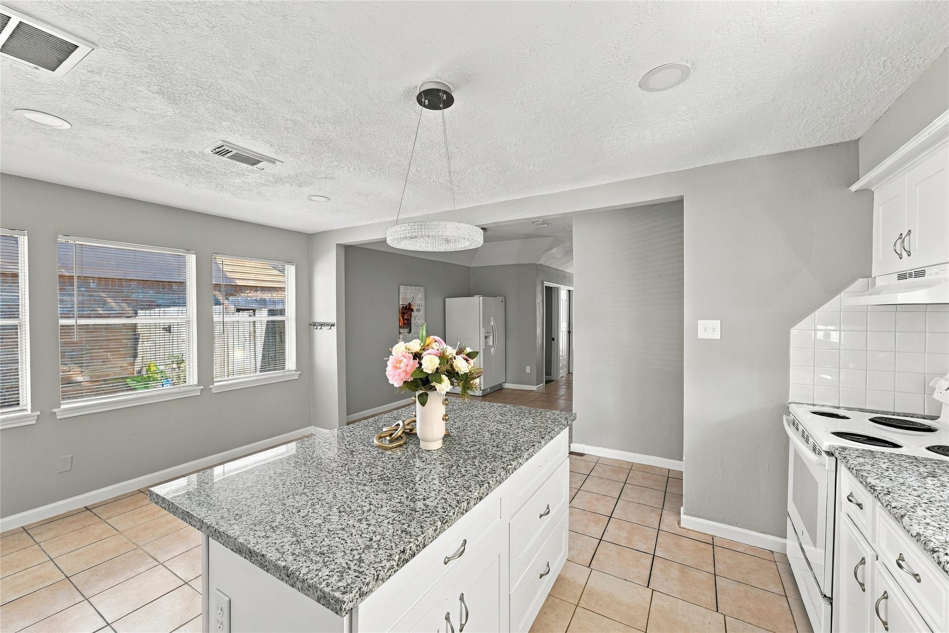 Open-concept kitchen with granite countertops and modern finishes