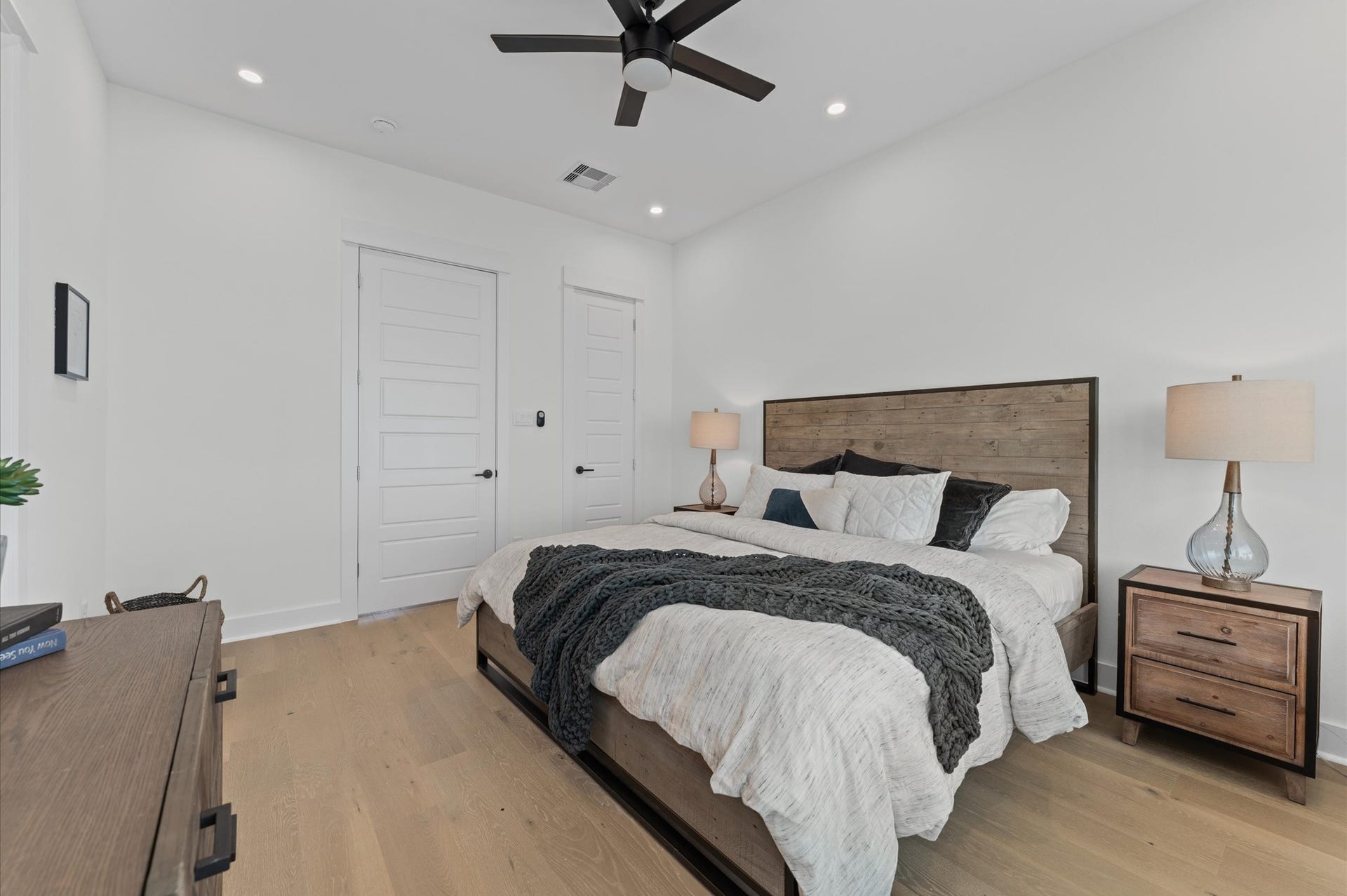 This spacious second-floor primary bedroom exudes modern elegance with its sleek engineered wood flooring that adds warmth and texture underfoot. High ceilings and big windows amplify the sense of openness, allowing natural light to cascade in and highlight the rooms charm. Whether styled with minimalist furnishings or layered with cozy accents, the space offers a serene retreat.