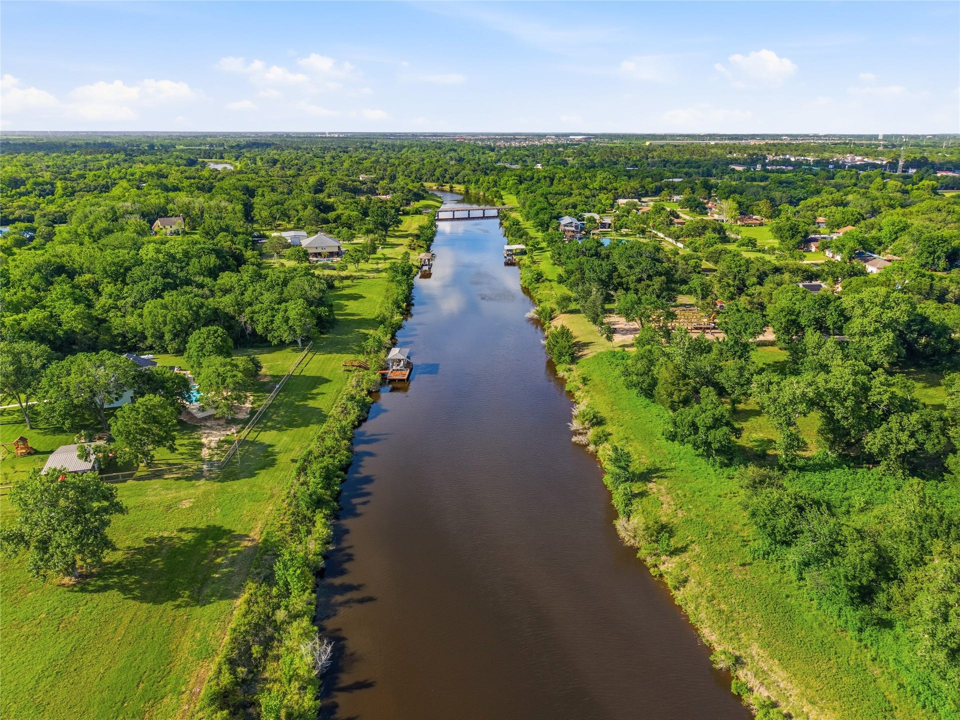 7334 Custer Street, Hitchcock, TX 77563 Serene, tree-lined river with nearby residential properties, offering a picturesque and peaceful setting ideal for homeowners seeking a scenic and tranquil environment.