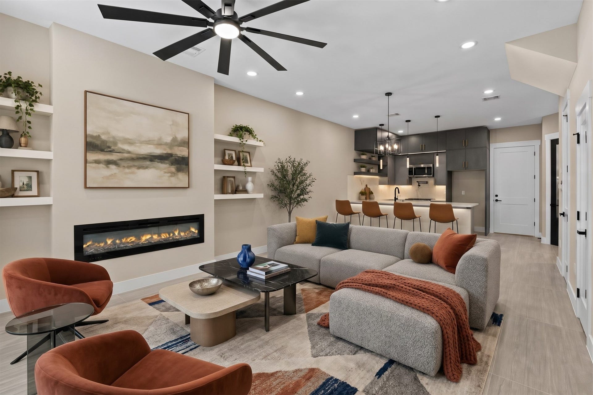 2412 Terry Street, #B, Houston, TX 77009 Virtually Staged: Offering a warm and inviting footprint, this main living area highlights clean architectural lines and integrated features. Built-in display shelving frames a ribbon fireplace, adding sophisticated style to the main seating area.