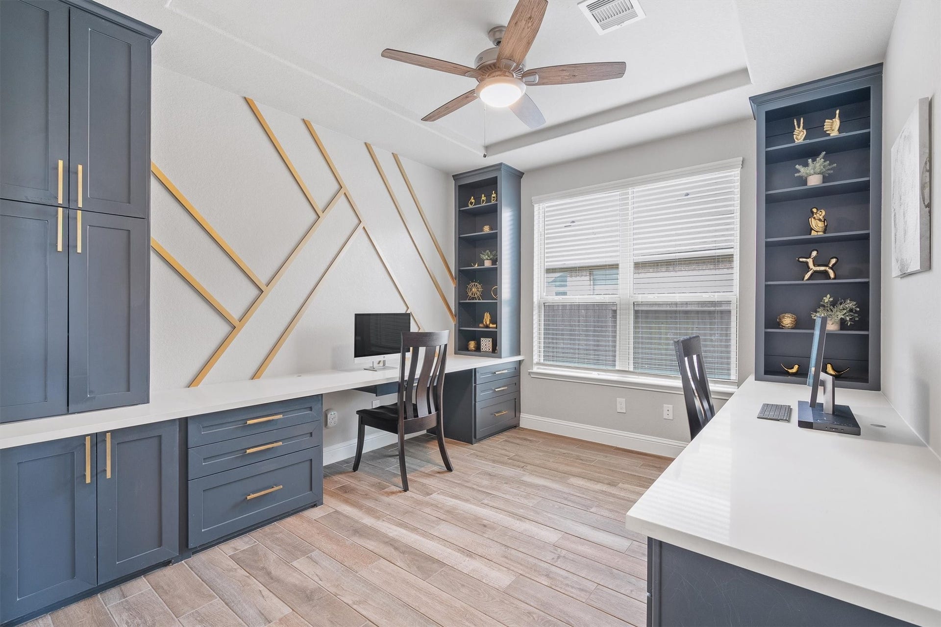 9034 Japonica Drive, Rosenberg, TX 77469 Work-from-home goals officially unlocked. That geometric accent wall and custom navy cabinetry are an absolute mood!