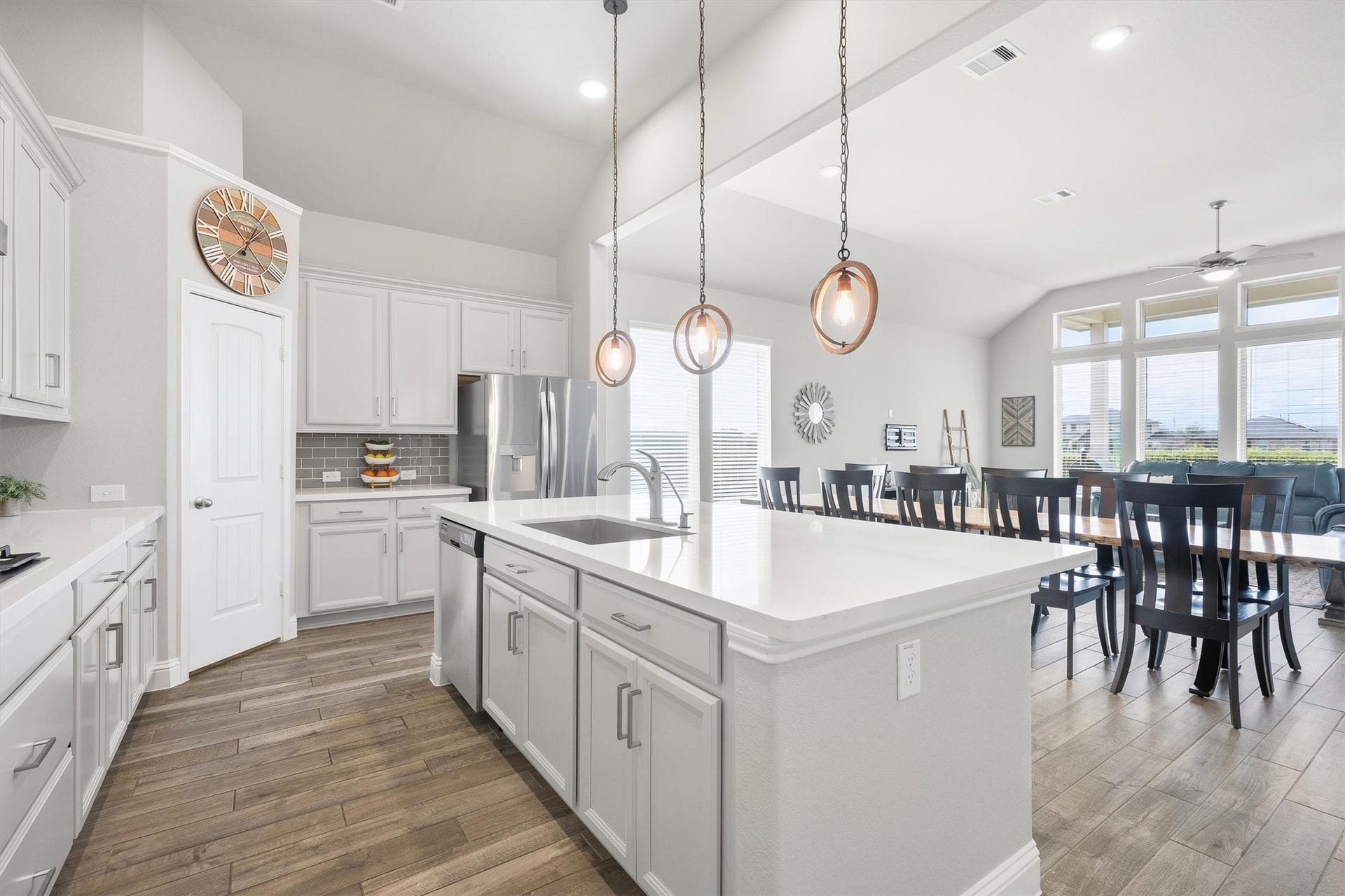 9034 Japonica Drive, Rosenberg, TX 77469 Step inside your modern dream home featuring a pristine white kitchen and a classic gray subway tile backsplash.