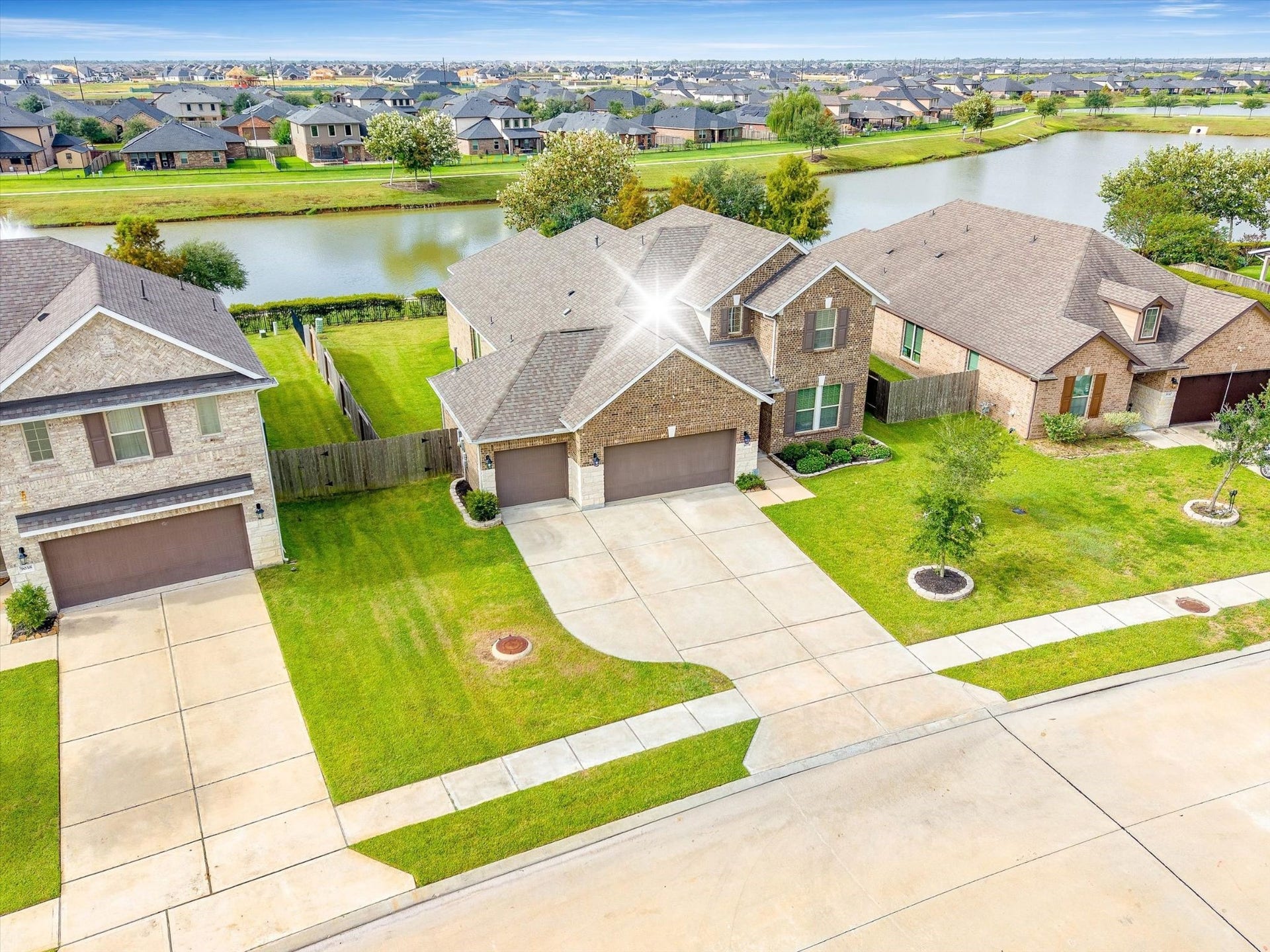 9034 Japonica Drive, Rosenberg, TX 77469 Birds-eye view of pure perfection. Blue skies, green lawns, and lake views right in your backyard!