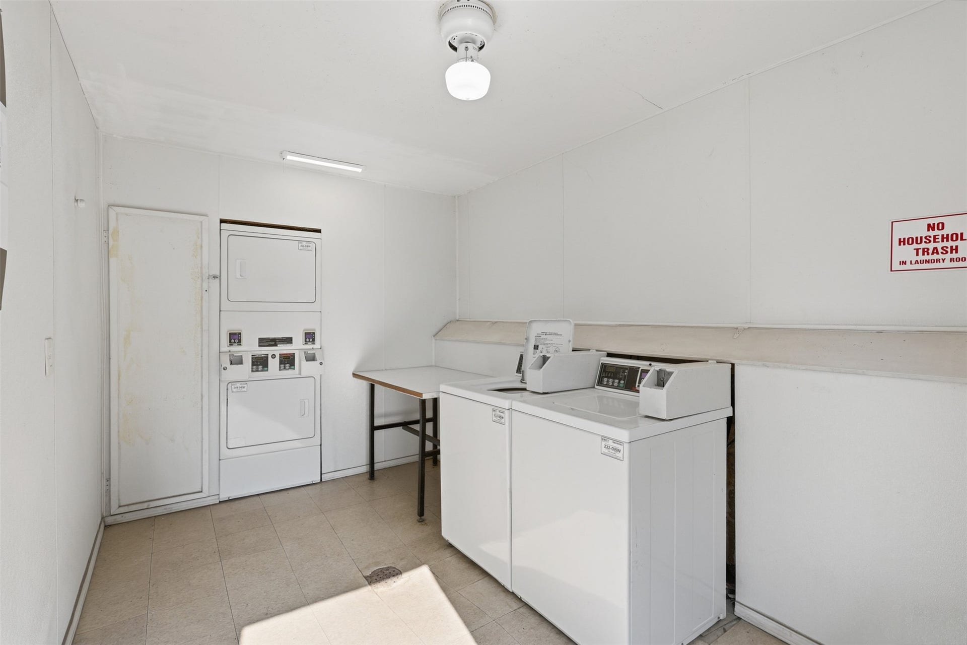 7600 Burgoyne Road, #250, Houston, TX 77063 Efficient and functional, this laundry room features modern stacked units and ample folding space, streamlining your daily chores with ease.