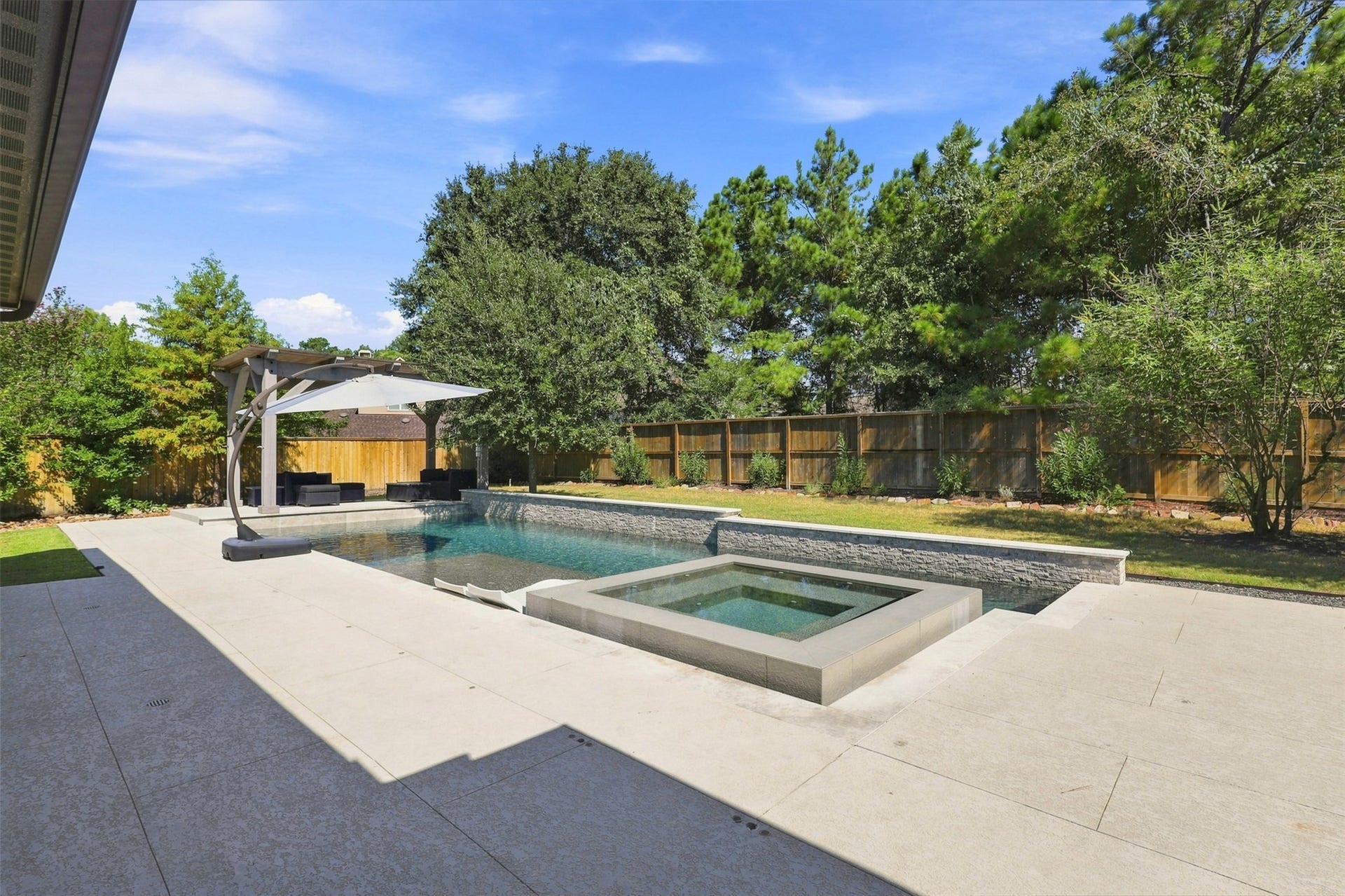 35 Gracenote Place, The Woodlands, TX 77375 Enjoy the heated pool and attached hot tub year-round, creating the perfect setting for entertaining, relaxing, and making memories.