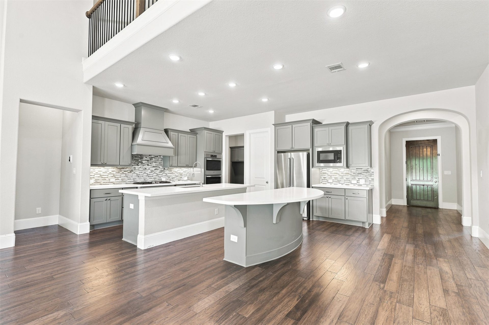 35 Gracenote Place, The Woodlands, TX 77375 Dual islands providing ample countertop space and seating, perfect for cooking, gathering, and entertaining.