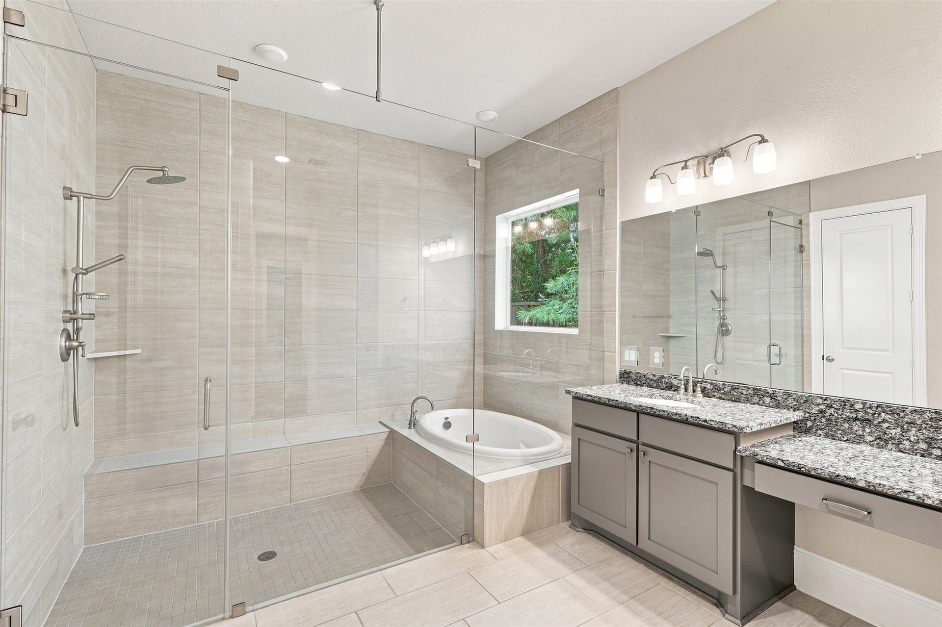 35 Gracenote Place, The Woodlands, TX 77375 A stunning primary bath showcases a large soaking tub within the walk-in shower, offering a unique design and spa-like feel.