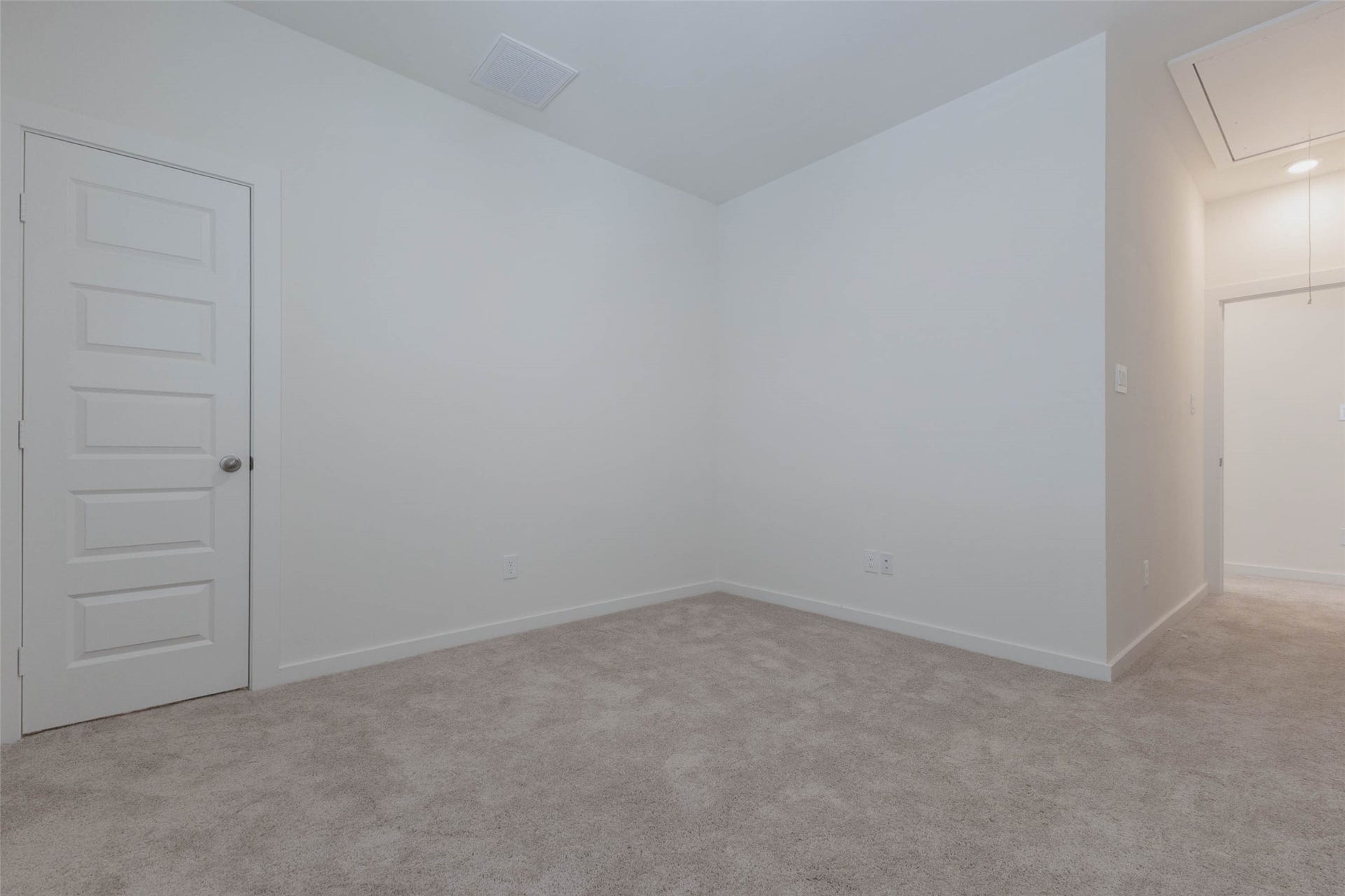 1115 Santee Court, Rosharon, TX 77583 Another carpeted bedroom is bright and roomy, with space for a queen bed, nightstands and a dresser. A closet door sits to the left, and an attic access in the ceiling gives bonus storage for seasonal items. Fresh white paint and plush carpet make this a comfortable, move-in-ready room for family, guests or a quiet home office.