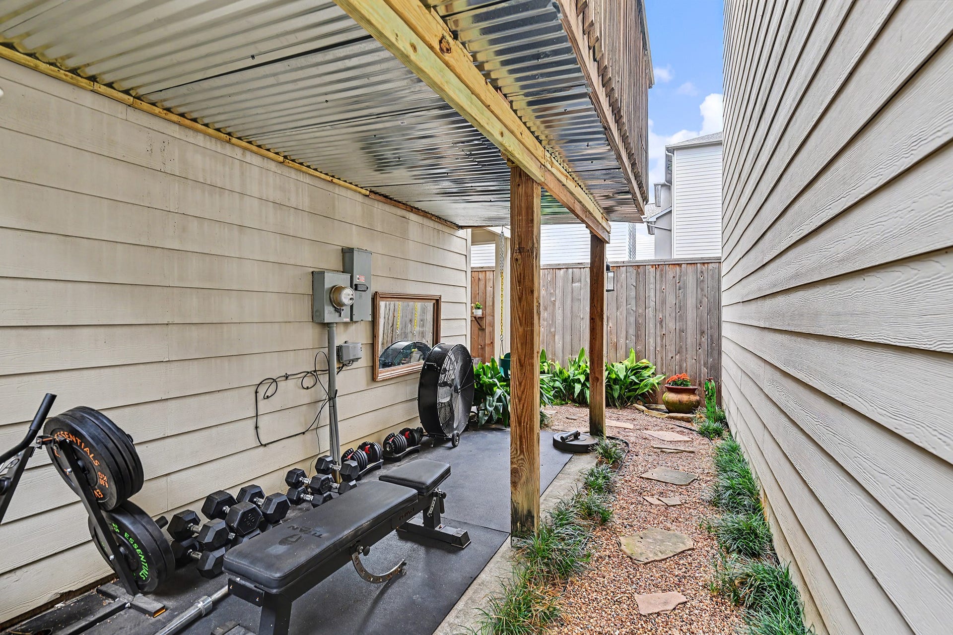 Side yard with covered workout area that could be used for whatever suits your needs