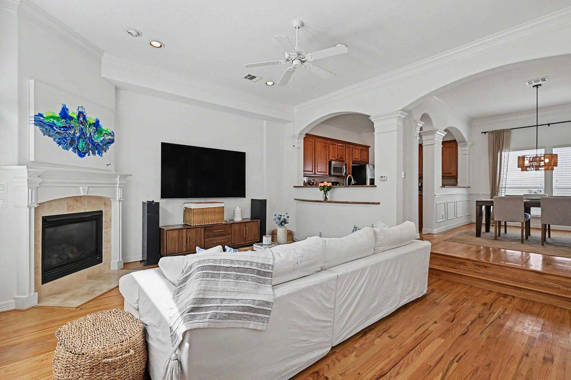 Kitchen and dining open to the living room featuring high ceilings and hardwood floors