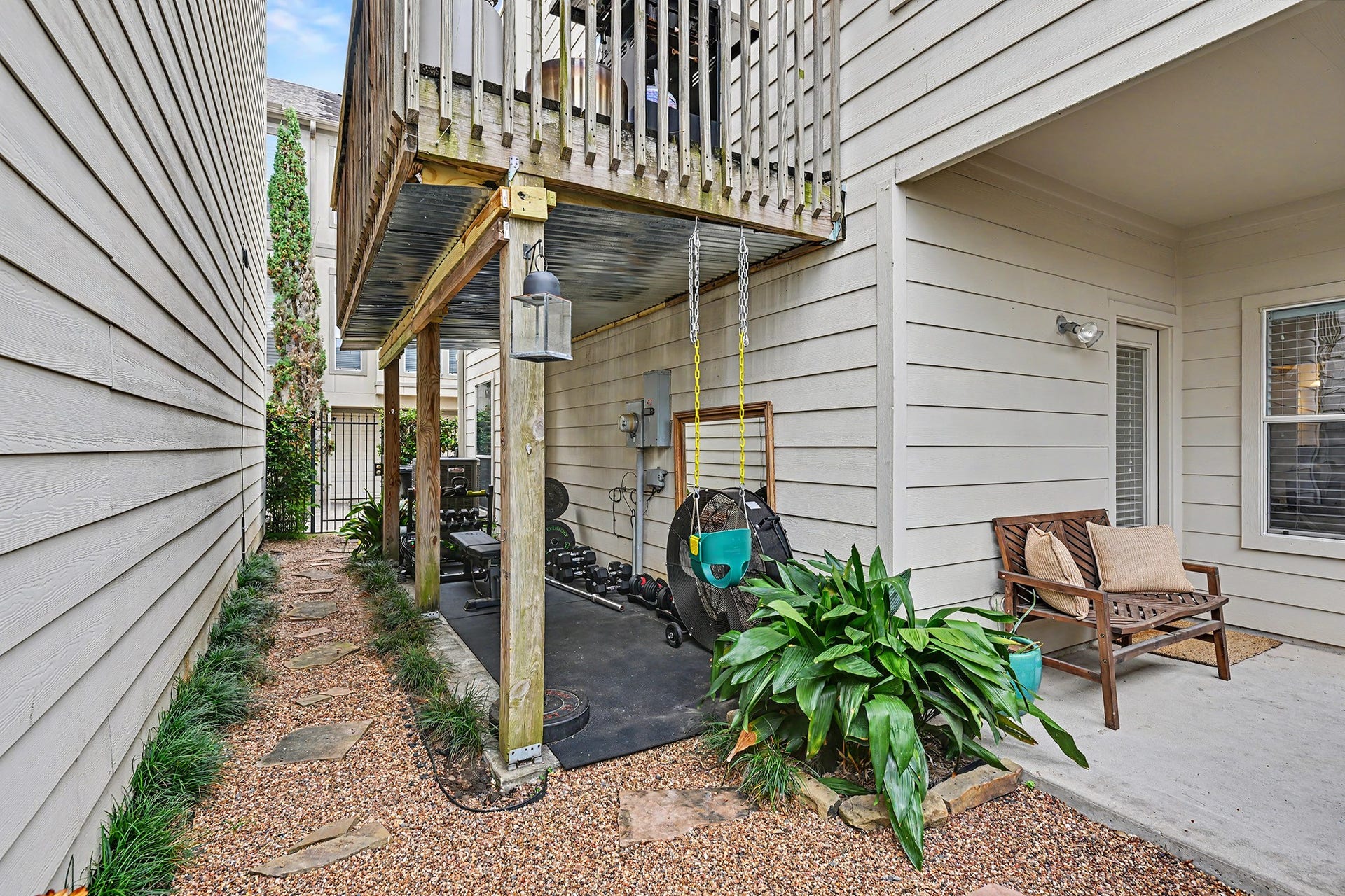 Wraparound yard with patio and covered workout area