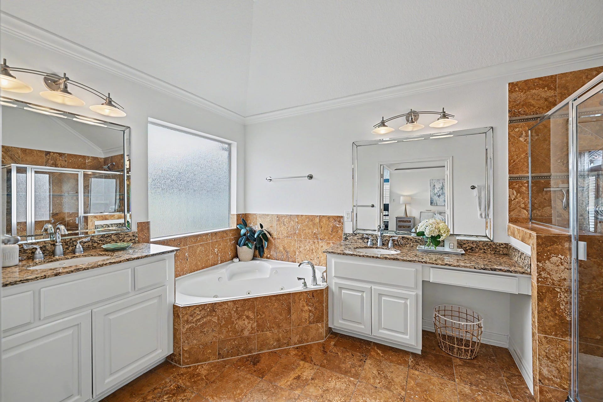 Double vanity, spa tub and walk-in shower in the primary bath
