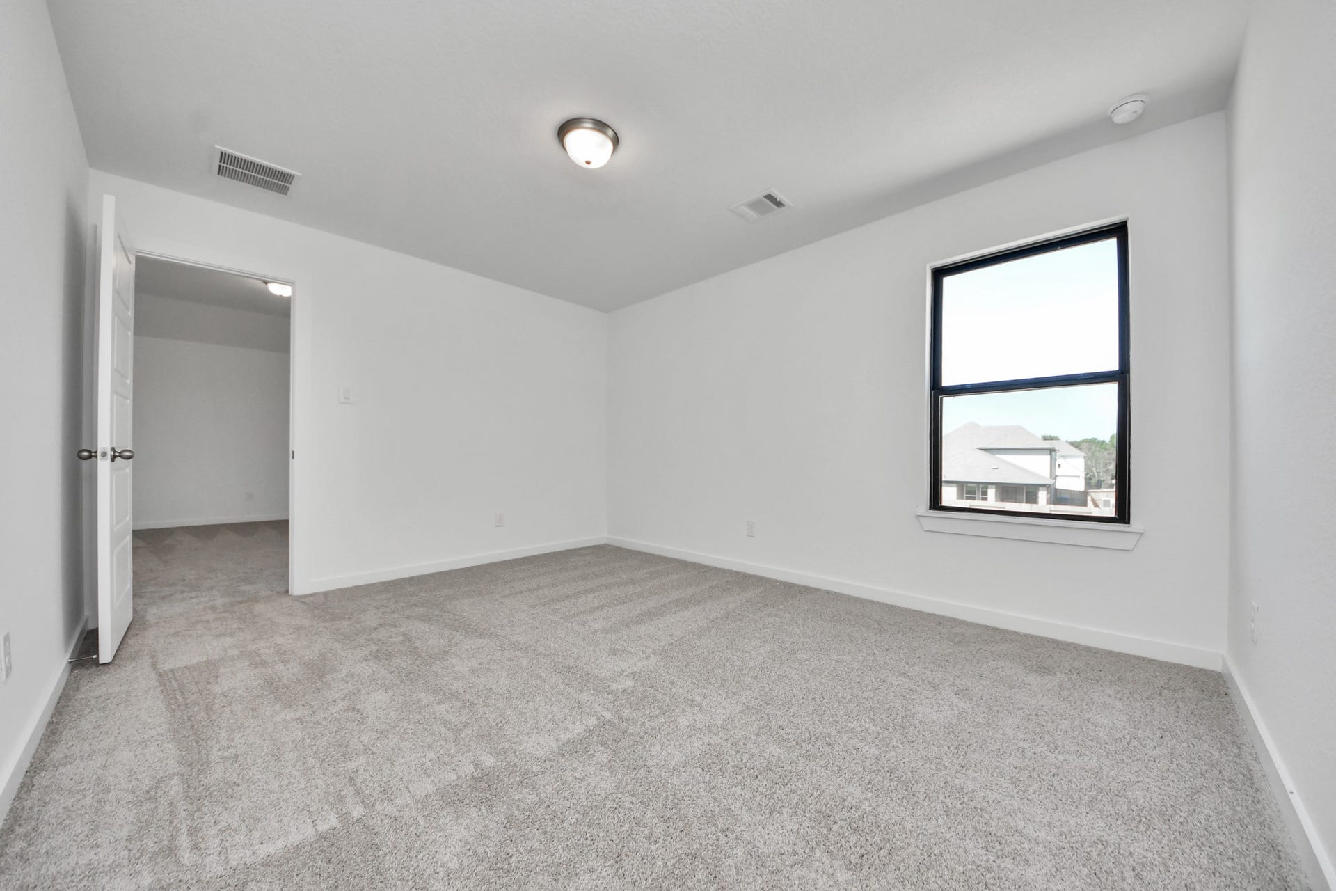 1017 Golden Glow Path, Magnolia, TX 77355 Generously sized secondary bedrooms featuring spacious closets, soft and inviting carpeting underfoot, large windows allowing plenty of natural light, and the added touch of privacy blinds for your personal retreat.