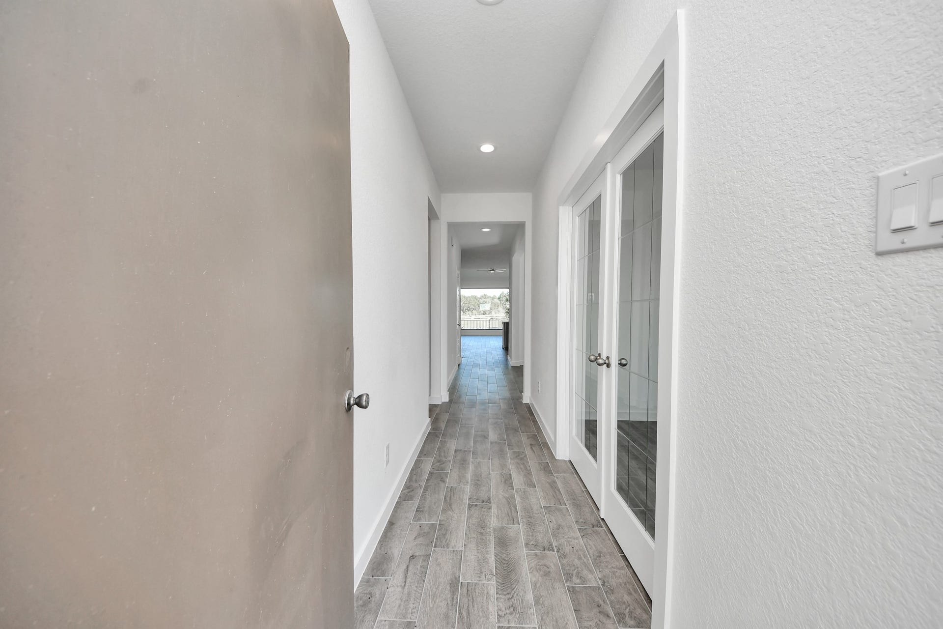 1017 Golden Glow Path, Magnolia, TX 77355 As you step into the threshold of this luxurious home, you'll soon be welcomed by an elegant glass door (to be installed). Inside, soaring ceilings amplify the spaciousness, while the refined wood-look tile flooring and oversized baseboards exude sophistication and charm.