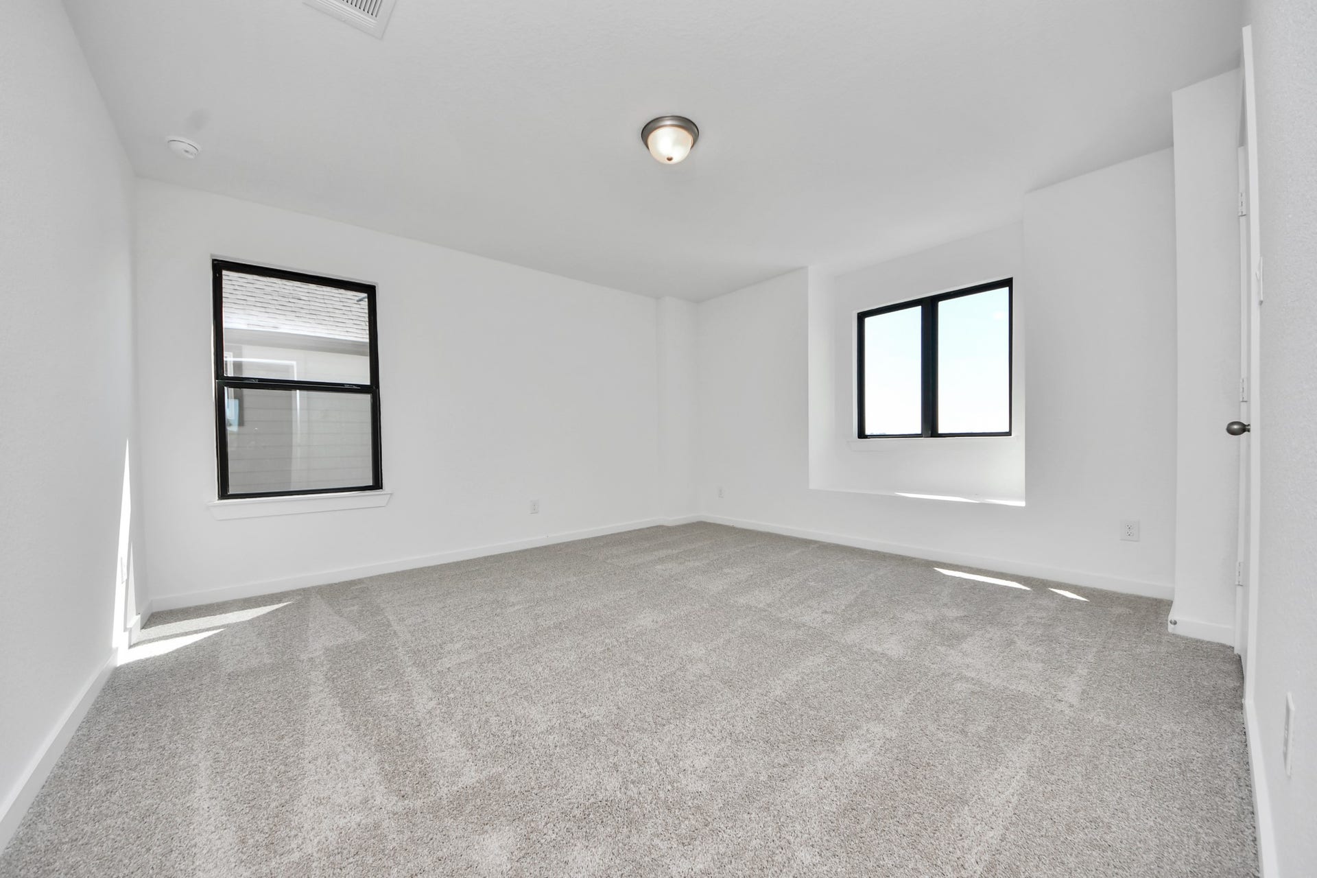 1017 Golden Glow Path, Magnolia, TX 77355 Generously sized secondary bedrooms featuring spacious closets, soft and inviting carpeting underfoot, large windows allowing plenty of natural light, and the added touch of privacy blinds for your personal retreat.