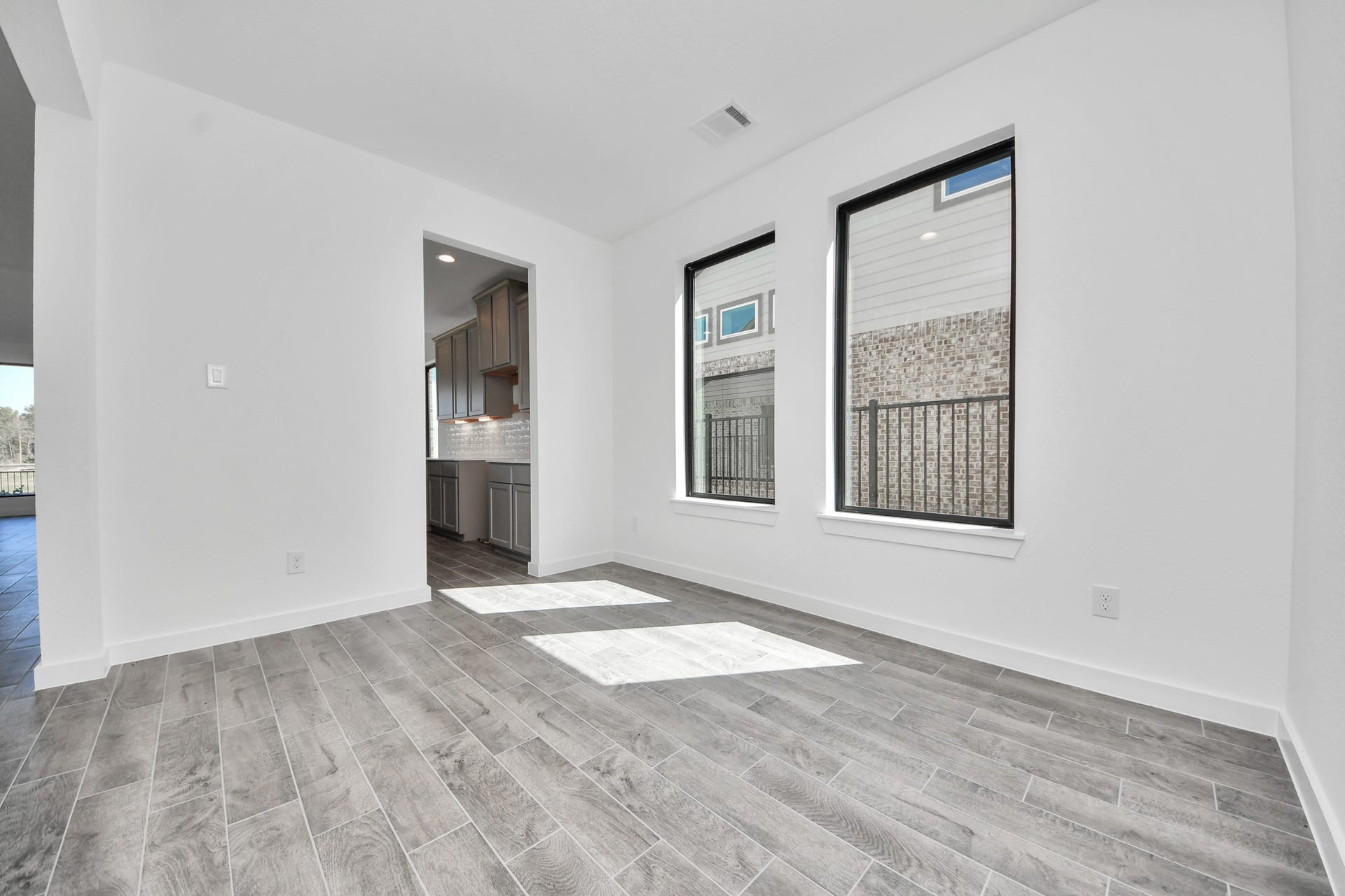 1017 Golden Glow Path, Magnolia, TX 77355 Make memories gathered around the table with your family and friends! This spacious dining room features elegant flooring, custom paint, and adjacent to family room and kitchen for open concept feel.