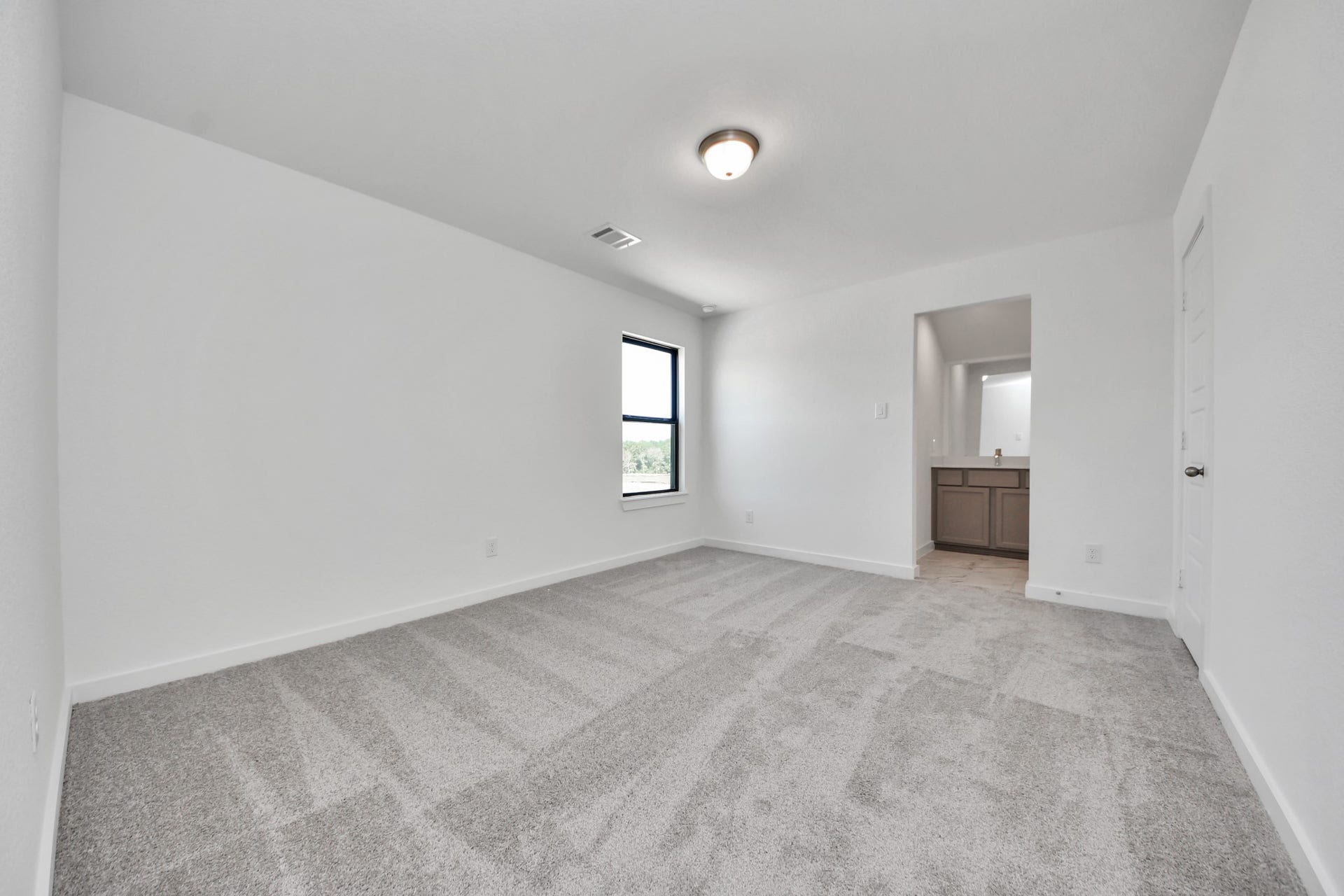 1017 Golden Glow Path, Magnolia, TX 77355 Secondary bedroom features plush carpeting, large windows that let in plenty of natural light, bright paint, and spacious closets.