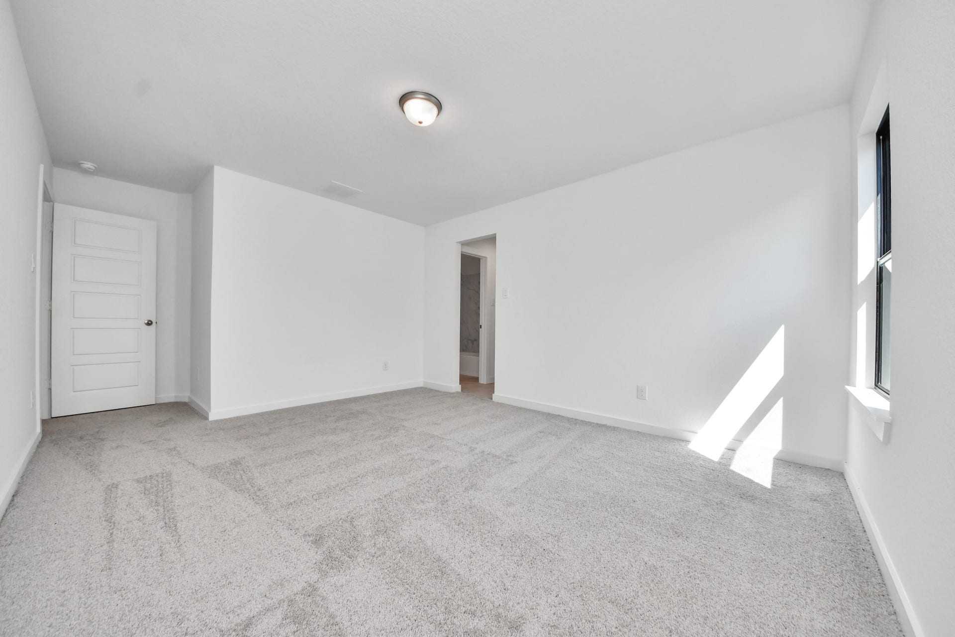 1017 Golden Glow Path, Magnolia, TX 77355 Secondary bedroom features plush carpeting, large windows that let in plenty of natural light, bright paint, and spacious closets.
