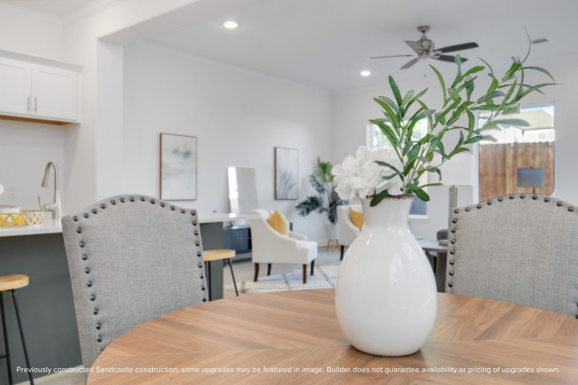 Oversized windows line the back wall, filling your home with natural light and offering a welcoming view to the private, fenced backyard.